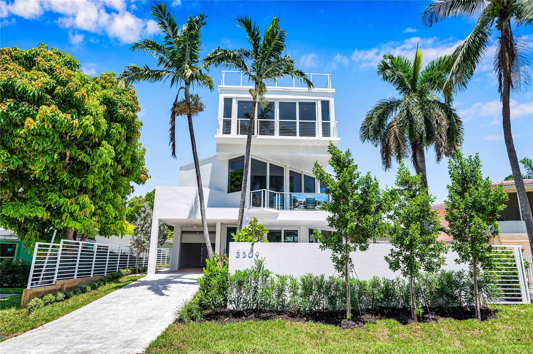 Here is an opportunity to live in a brand new ocean-facing home in the sought-after Lauderdale Beach neighborhood tucked away east of A1A. On a palm-shaded boulevard, this magnificent, glass walled house faces a beach side pocket park and the azure Atlantic. The entry level is for entertaining with a spacious family room that opens to a roofed patio and two saltwater swimming pools, one 41 feet long. A guest suite, wet bar and powder room on this level keep your guests comfortable. The main floor has high ceilings, floor to ceiling glass and a great room with DACOR gas kitchen and two more guest suites. The 3rd floor primary suite has three closets and a wide balcony with sweeping views. The elevator or stairs take you up to a roof deck for sunbathing or watching the stars and the horizon.