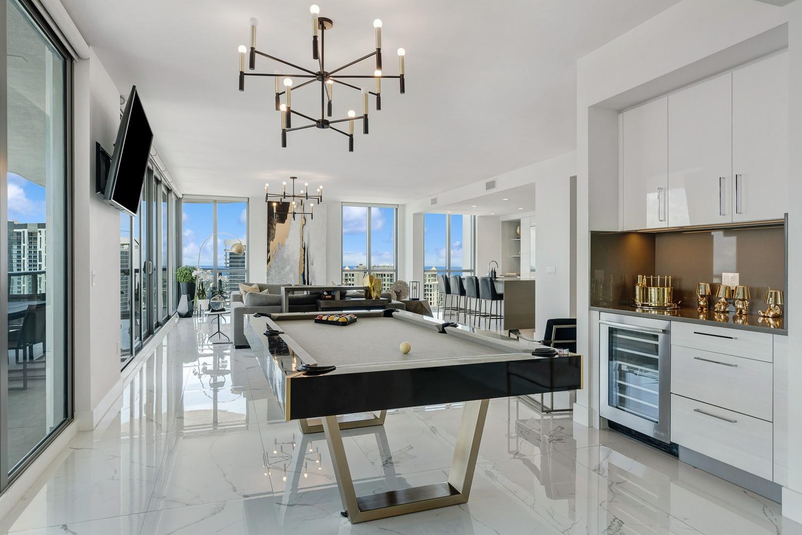 This luxury unit soars 40 floors above the city center, offering mesmerizing skyline views through floor-to-ceiling windows. The 1 of 6 estate plan features private elevator entrance, access-controlled entry points, a 4-bedroom, 4.5-bath plan with a formal dining room, family room, theatre room, premium flooring, European kitchen cabinetry, quartz countertops, high-end fixtures and private terraces with glass railings designed for unobstructed city views.

This unit seamlessly blends indoor and outdoor living and offers four tranquil bedroom suites. Perfect views and spaces for entertaining; you can serve guests in the eat-in kitchen, formal dining room, or step onto the sky terrace for panoramic sunsets.
