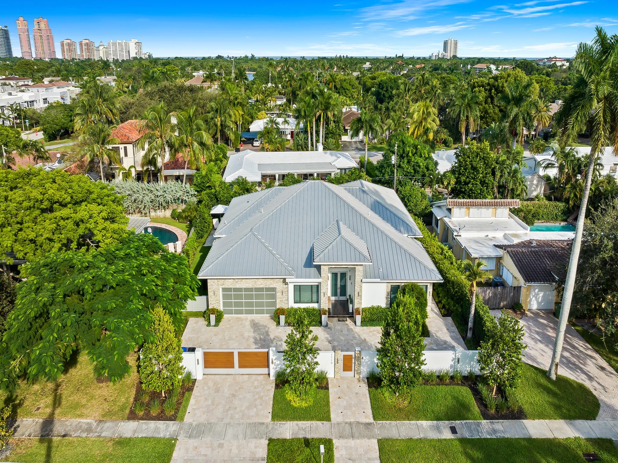 Unrivaled architecture & design defines this luxurious residence in East Fort Lauderdale's coveted subdivision of Coral Ridge. Every element has been created to cultivate today's modern lifestyle & open concept living with soaring ceilings & walls of glass doorways providing a luminous floor plan. Multiple doorways bridge indoor outdoor living spaces enhanced by an enormous covered loggia w/multiple seating areas, a summer kitchen & heated pool complete with a sun shelf & spa. The culinary kitchen is ideal for the avid chef with upgraded appliances, tremendous storage & oversized center island for entertaining. The primary suite boasts a custom walk-in closet & spa inspired bathrm.  Details include: en-suite guest rooms, home office, home generator, gated entry & more. Sq ft from seller.