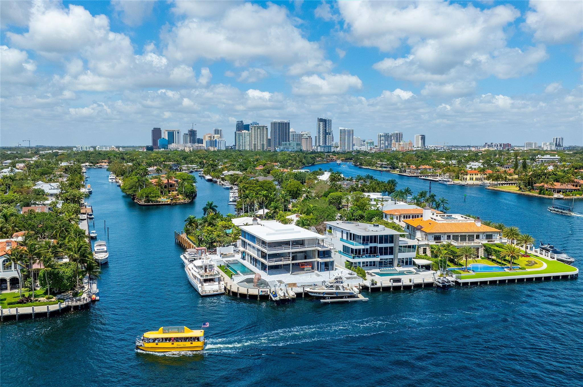 This ultra-luxurious waterfront Point Lot estate, in Fort Lauderdale's prestigious Rio Vista, offers the ultimate showcase of wide-open Intracoastal views! This stunning 3-story modern masterpiece spans 9,500+ sq. ft. of chic indoor living, is complemented by multiple private terraces for both sunrise & sunset enjoyment. Boasting 6 bedrooms; gourmet Chef's Kitchen; soaring volume ceiling in living room; office and clubroom; an indoor/outdoor primary bath; and third-floor Gym & Spa - this home has it all! With 255' of deep water dockage, you can accommodate your mega yacht while relishing the broadest Intracoastal panorama. While outdoors enjoying the views, soak in your custom glass facade pool, a summer kitchen & an array of water features! Just minutes to the ocean, beach and airport!