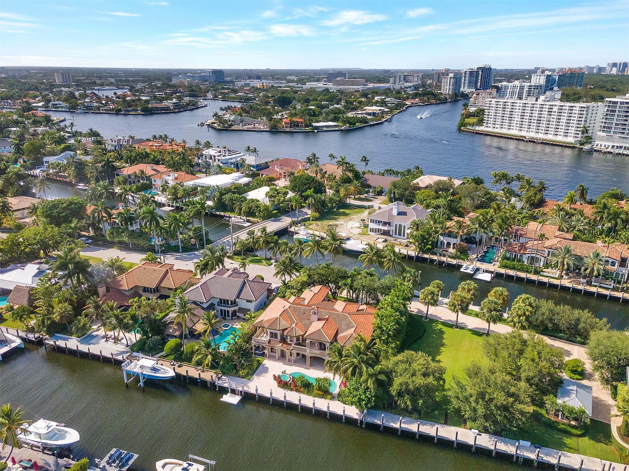 Stunning Seven Isles Gated Waterfront Estate, on private gated street, one off intracoastal point, 100' of waterfront on south canal and 103' on north canal, 203' combined for multiple yachts of 80'-83'. Water Views from each bedroom, curved marble Iron Staircase, marble and wood floors, chef's kitchen, fabulous great room with 20' ceilings and 2 story stone fireplace. Main suite features his and her baths, sitting room and morning bar, 2 balconies. Guest suite on 1st Floor. Beautiful, expansive outdoor covered area with tumbled marble patio, and heated pool. Estate features 5 bed, 7.5 bath, office, theater, basement, 3CG, elevator, Lutron Lighting. Guardhouse at Seven Isles entrance offers security with high res camera recording vehicle tags. Walk to Las Olas, beach, dining, and shopping.