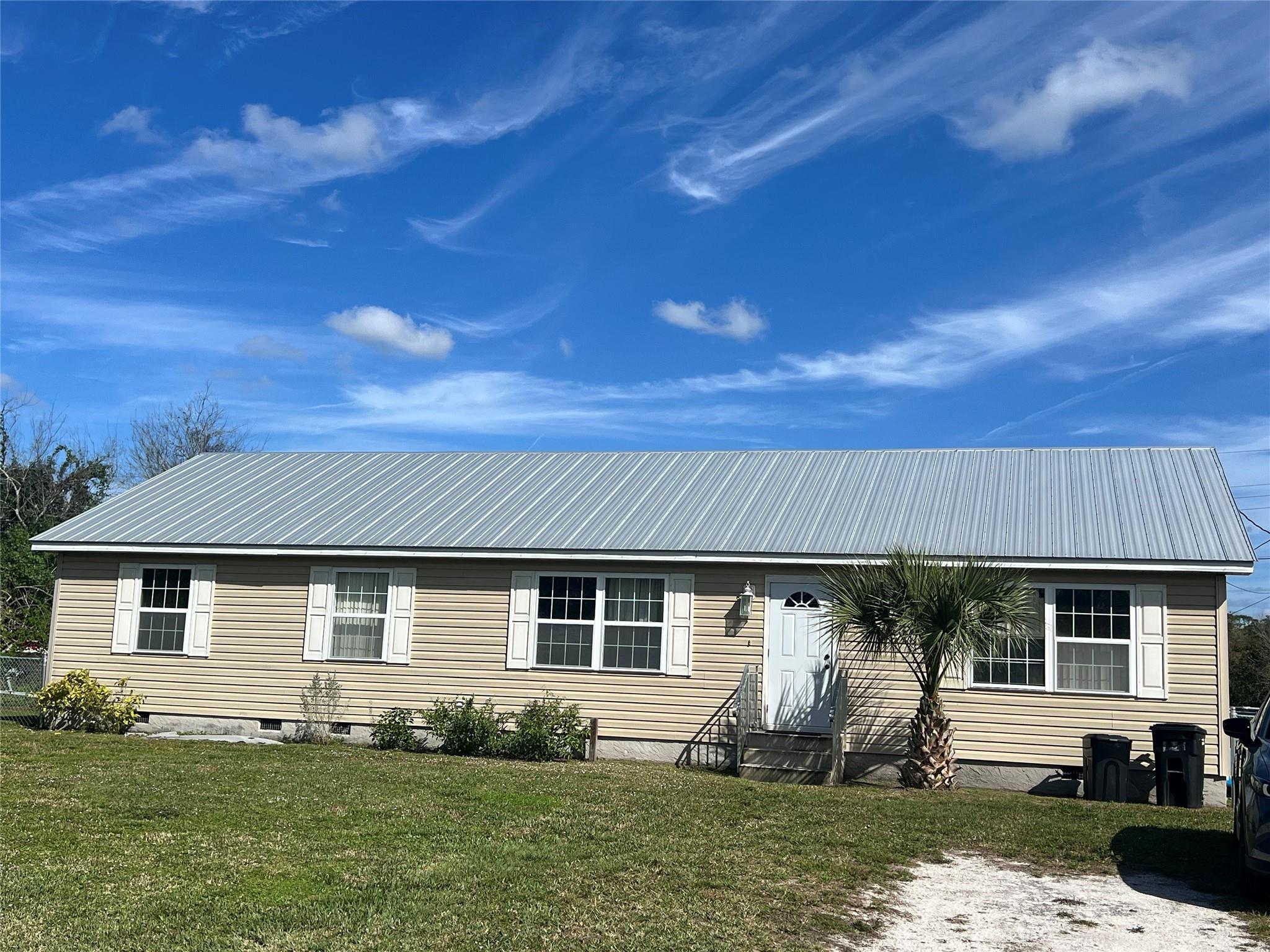 This tranquil modular home offers 3bd/2ba with an office, a new metal roof, and a fully fenced yard! Located in the southeastern area of Okeechobee, it is perfect for the commuter to the east coast of Florida! Step inside to discover a thoughtfully designed interior that seamlessly blends functionality with a cozy atmosphere. The open floor plan creates a sense of spaciousness, making it ideal for both relaxation and entertaining. The well-appointed kitchen is equipped with modern appliances and offers plenty of counter space for culinary enthusiasts. This home won't last long, call today!