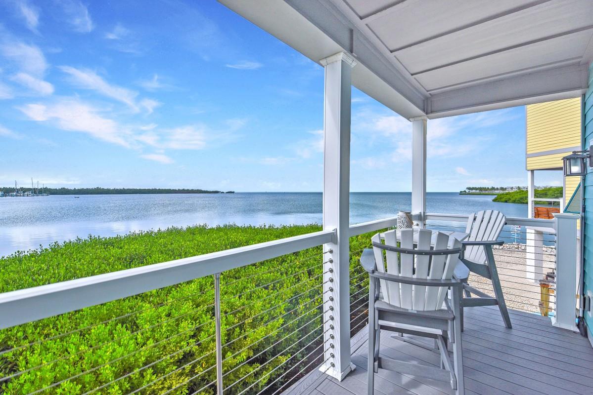 Spectacular unobstructed ocean views from your turn-key, 2 BD, 2 BA  elevated modern home in Ocean Breeze in the heart of the Fl Keys. This home is built to withstand 180mph winds with hurricane impact windows & doors. Covered parking for 2 cars. Enjoy resort-like amenities including an inground pool, an on-site marina with wet slips, and more. The property is subject to lot rent paid monthly.