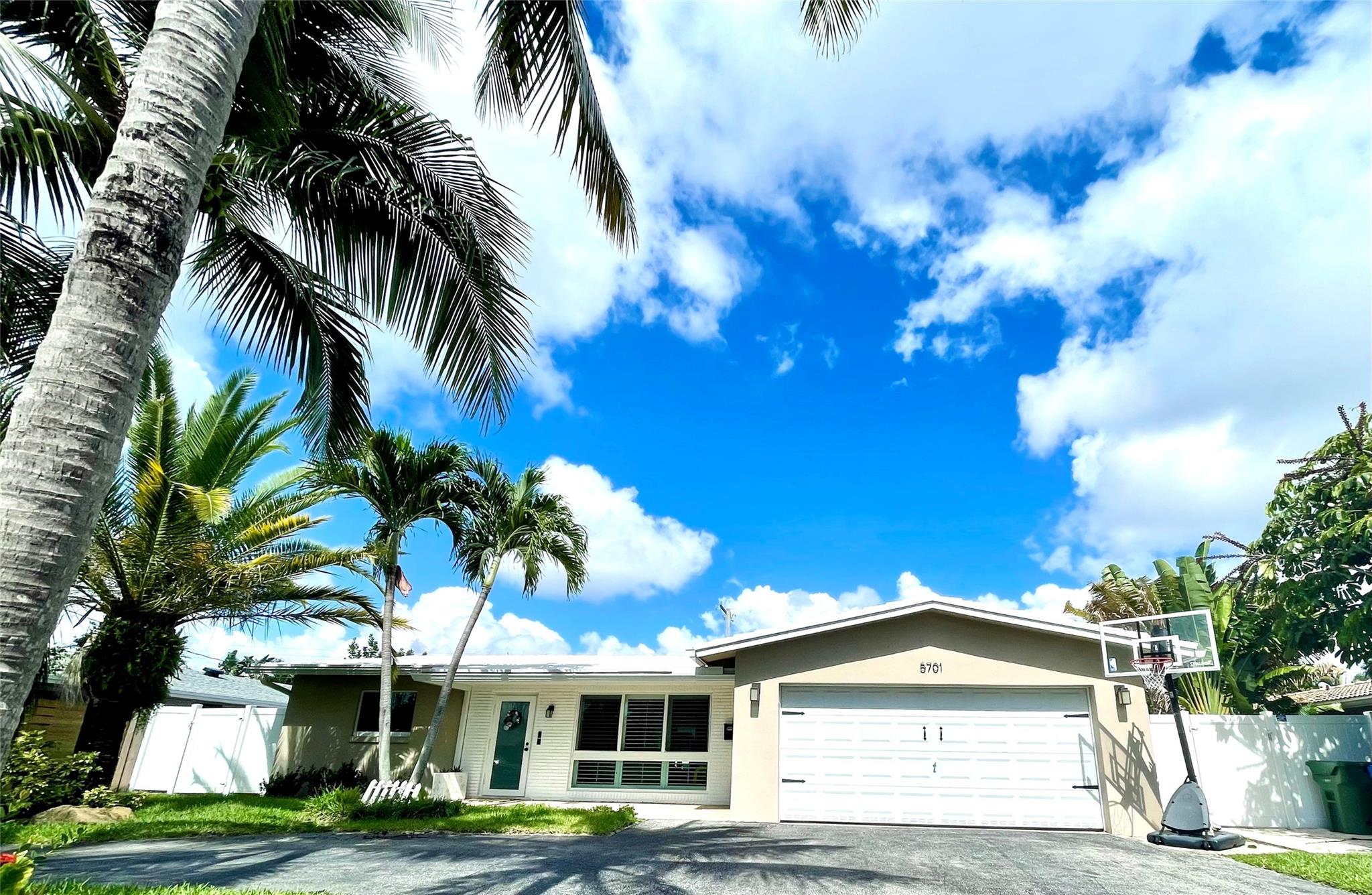 Turn-key fully furnished home in the popular Coral Ridge Isle neighborhood within 5 mins of the beach/Lauderdale by the Sea & 10 mins from downtown Ft Lauderdale. The home features an updated kitchen with marble backsplash, granite countertops, stainless appliances, and a double sink that overlooks your dining & living room areas. Out back you'll find a partially covered area with travertine flooring surrounding the large screened in pool, with furnished extended travertine deck & turf for the perfect backyard oasis. Added bonus for Florida living: a whole house gas generator & full impact doors & windows. No HOA, able to be rented or airbnb immediately!