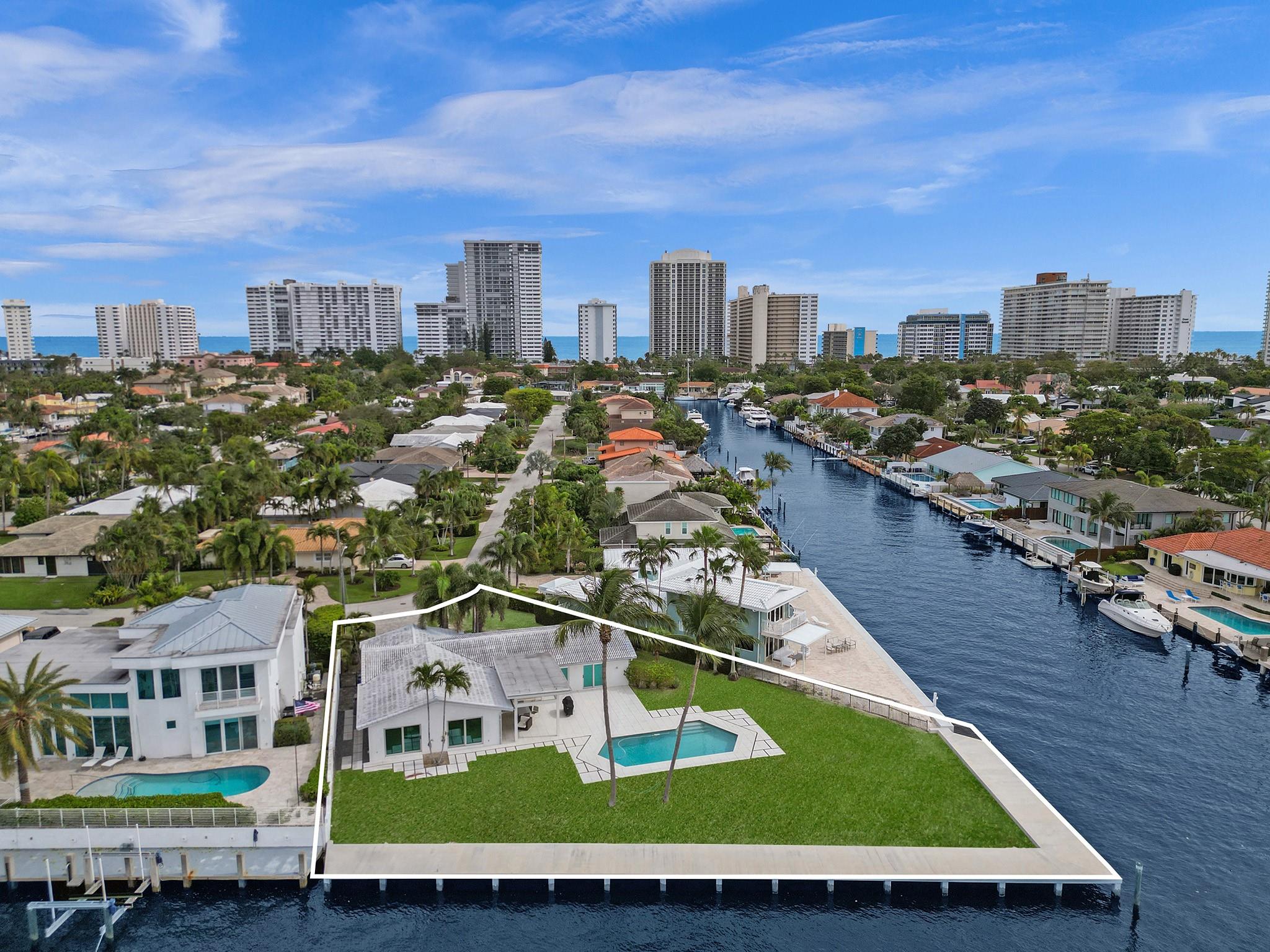 RARELY AVAILABLE POINT LOT IN HIGHLY DESIRABLE BERMUDA RIVIERA! One-of-a-kind home featuring approx. 140' on the Intracoastal & 51.9' on the canal! Build your dream home on this oversized 14,661 SF lot or add to the existing 3 bed, 2 bath newer construction modern minimalist home. Ultra contemporary walnut concealed kitchen w/ Miele & Thermador appliances! Open floor plan w/ floor-to-ceiling impact sliders allowing panoramic views to watch yachts go by & enjoy from your private backyard w/ pool! NEW concrete dock! High-end European fixtures & electric shades thru/out! Fully controllable remotely via phone or ipad! Short walk to Fort Lauderdale Beach, restaurants & shopping! One entrance guardhouse! Home being sold completely turn-key. Must see all this desirable property has to offer!