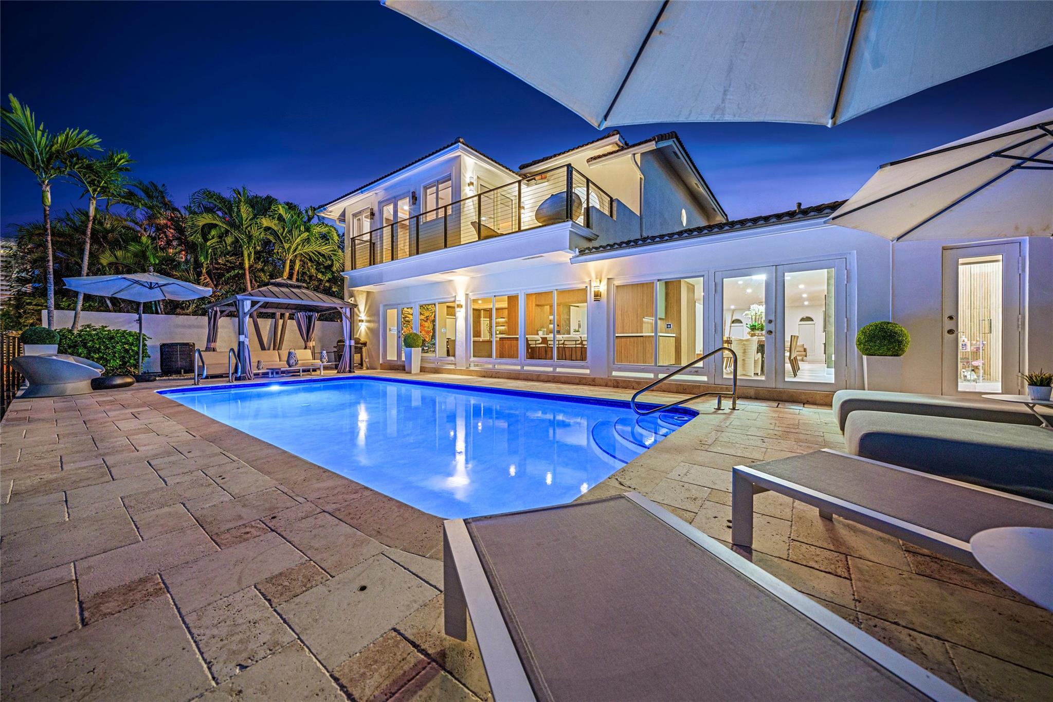 Nestled within Ft. Lauderdale's exclusive Castle Harbor Isle, this waterfront gem features an 80 dock, a fully remodeled interior, and over 4,000 sq ft to enjoy. This property is being sold as a LUXURY PACKAGE that includes a 2023 Ferrari F8 Spider, custom 2017 Harley Davidson Night Rod Special 1250 cc, 2 Yamaha Jet-skis, a Tidewater 280 boat, and all the furniture in the home.  Spacious floor plan, including a grand 2-story foyer, a kitchen overlooking the pool and intercoastal, jacuzzi, and an oversized balcony. Upstairs, the master suite offers a walk-in closet and a master bathroom worthy of a 5 star spa. Excellent location near the beach, dining, shops, major roadways, and the airport. Boater's dream with ocean access, no fixed bridges, minutes from Hillsboro Inlet!