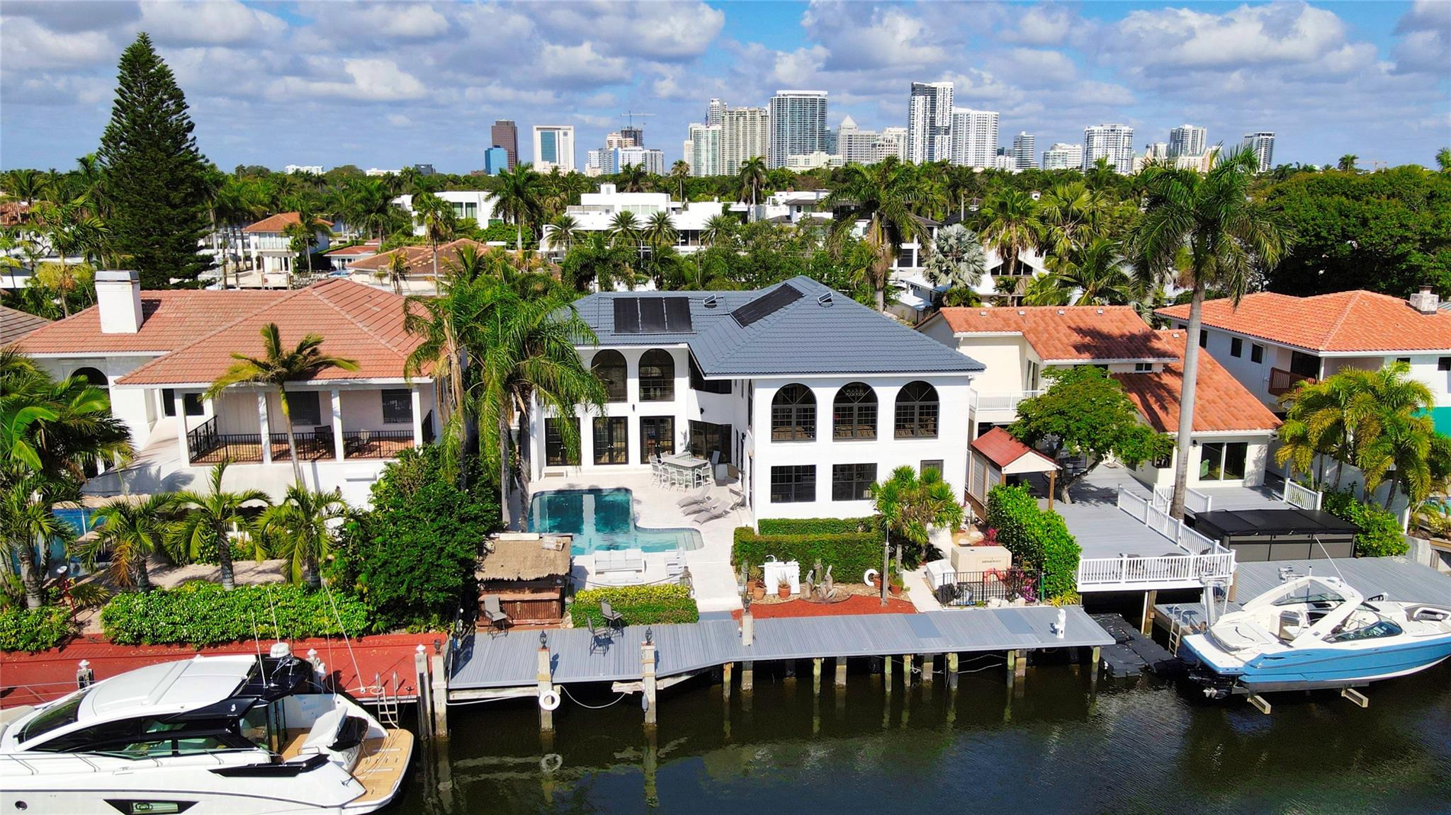 Sited on 70 ft +/- of Deepwater Dockage on the South side of Las Olas, offering quick access to Port Everglades by boat, this reimagined 5 Bedroom, 3 Full Bathroom, 1 Half Bathroom Coastal Residence boasts over 4,050 sqft of living space, with soaring ceilings, an open floor plan, and direct water views from every major room. Designed for entertaining, a grand living room leads to the open kitchen and waterside family room. French doors open to a large pool, jacuzzi, tiki bar/grill and new composite dock. Upstairs is dedicated to the owners suite, offering a huge bedroom with vaulted ceilings, nicely appointed master bath, a bonus loft or office, and a covered terrace with beautiful views down the canal. Other features include a cabana bath and a 2 car garage.
