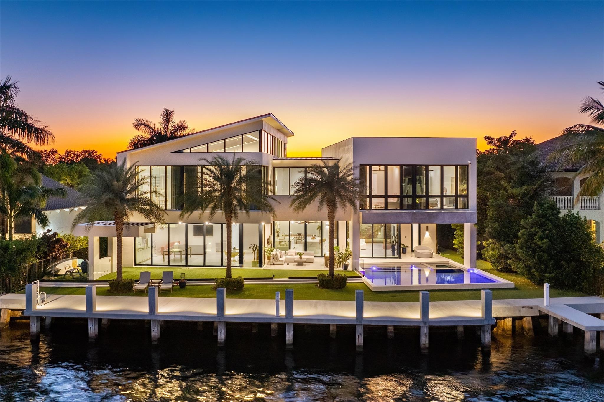 This sleek, contemporary, fully gated masterpiece by Affiniti Architects offers the ultimate lifestyle in luxury waterfront living with its high-end finishes & smart home technology. Open concept floor plan allows for seamless indoor/outdoor living, perfect for entertaining guests or enjoying your 105' of direct Intracoastal views. Find micro cement and wood flooring throughout, chef's kitchen w/ top-of-the-line appliances, custom cabinetry & double islands, wet bar & elevator. The primary suite is a true oasis with high ceilings, double walk-in closets, and spa-like bathroom complete w/ steam shower and soaking tub. Outside, the expansive outdoor living area features a saltwater pool, spa & brand new concrete dock perfect for enjoying waterfront activities or watching the boats pass by.