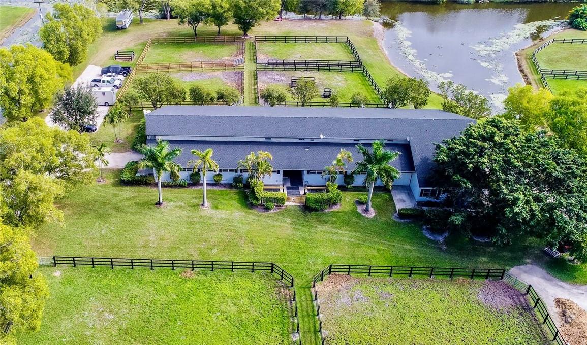 A stunning equestrian property situated on 10 acres. The barn features 24 stalls, tack and feed rooms, outdoor wash racks, a 2bd/1Ba apartment, and a 2bd/2ba apartment, groom quarters, 1 sand ring, and 1 grass field. 12 grass paddocks surrounding each side of the barn, 2 separate gated entrances off the paved road of Palm Beach Point Blvd.