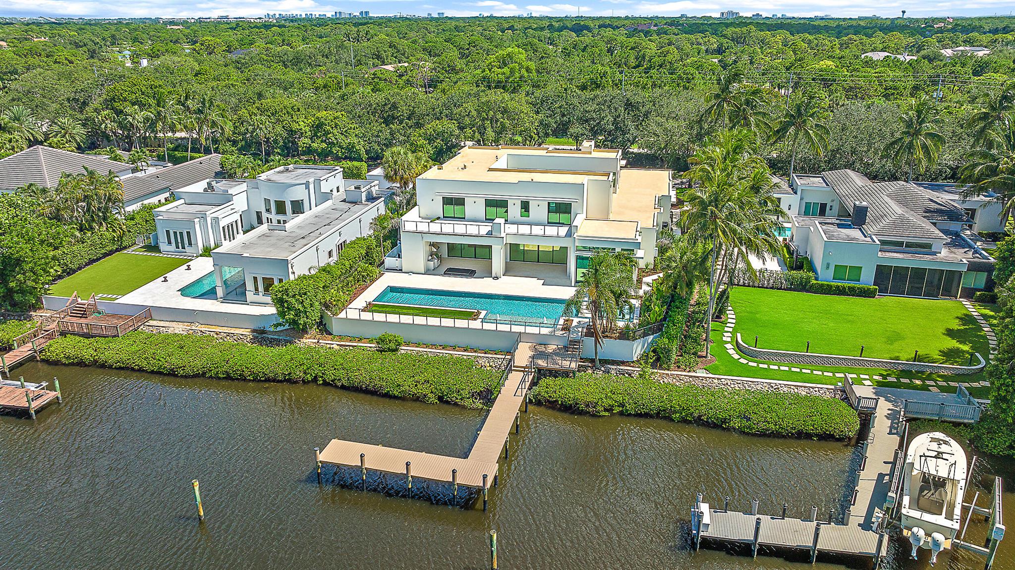 Welcome to 410 Mariner Drive, a contemporary waterfront masterpiece in the prestigious enclave of Admirals Cove. Featuring 7,998 sq ft of interior living space and a total living area of 12,253 sq ft, this new build seamlessly blends modern design with unparalleled amenities, making it the epitome of waterfront opulence.