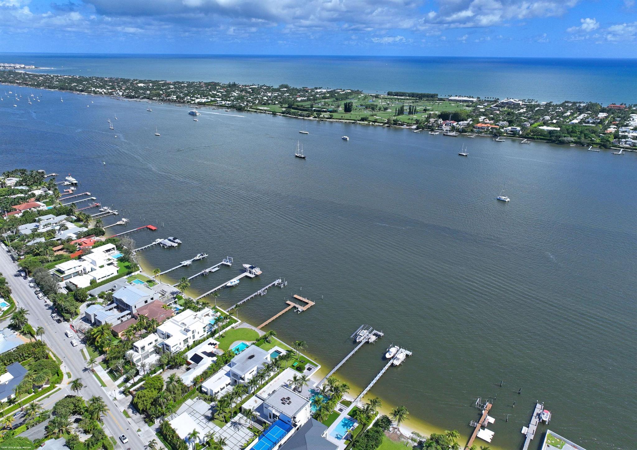 This Fabulous New Modern direct intracoastal waterfront home in West Palm Beach sits on a large 20,000 square feet lot. Spectacular design by architect David Lawrence with 12,730 total sq ft under roof, built at 10' above sea level, with 7 bedrooms, 8 full baths, 1 half bath, a 40' pool, a waterfront spa/hot tub, roof top decks, boat dock/lift, and a generator. Landscape designed by John Lang and being built by Tri General Contractors. Completion early spring of 24.