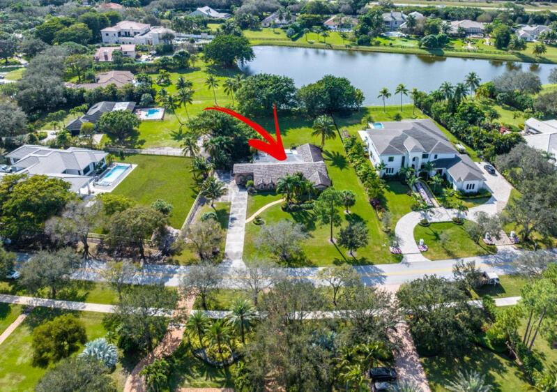 Amazing opportunity to build or renovate the existing CBS house into your dream home on 1.03 acres in Steeplechase, a private gated community. This offering is perhaps the prettiest, most desirable wide water lot in the community. Positioned in between 2 of the most expensive new construction already built homes so no one building or renovating next to you.  This unique neighborhood features custom estates situated on more than one acre with mature trees, stunning manicured landscaping, brightly colored Florida wildlife, and sparkling waterways throughout. Steeplechase is close to I95, Florida Turnpike, and abundant shops and restaurants. This property is being sold for lot value with a perfectly livable 5 bedroom existing home in place.