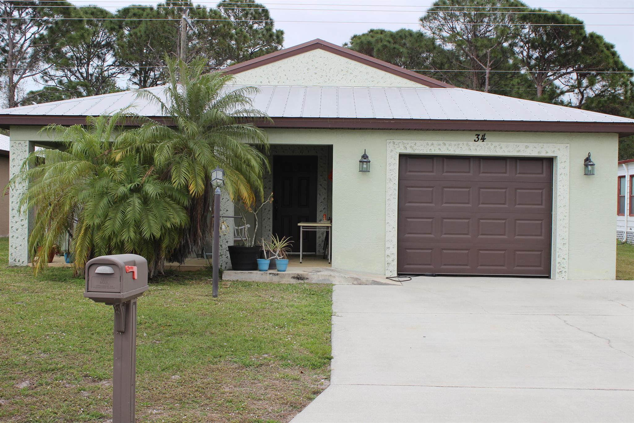 Newer home built in 2016 with the LOWEST LOT RENT YOU WILL FIND just  $458.25 for the next home owner! Build in 2016 this wheel chair accessible home has a metal roof, granite kitchen, laminate floors plus the rear porch is fully enclosed as a sitting room with AC and French doors, overlooking the private back yard with no neighbors in the rear. Located close to the clubhouse where you will find all the wonderful amenities that Spanish Lakes has to offer including a  Private golf course ( no fees to play,) 2 pools, pickleball, tennis, shuffleboard, bocce, gym, library, cards, Mah jong, bible study, wood workshop, golf cart parades, dinners, dances, trips and so much more! Grass cutting is also included as is trash removal. 55+ community, no HOA fees just land lease fee.  Priced to sell.