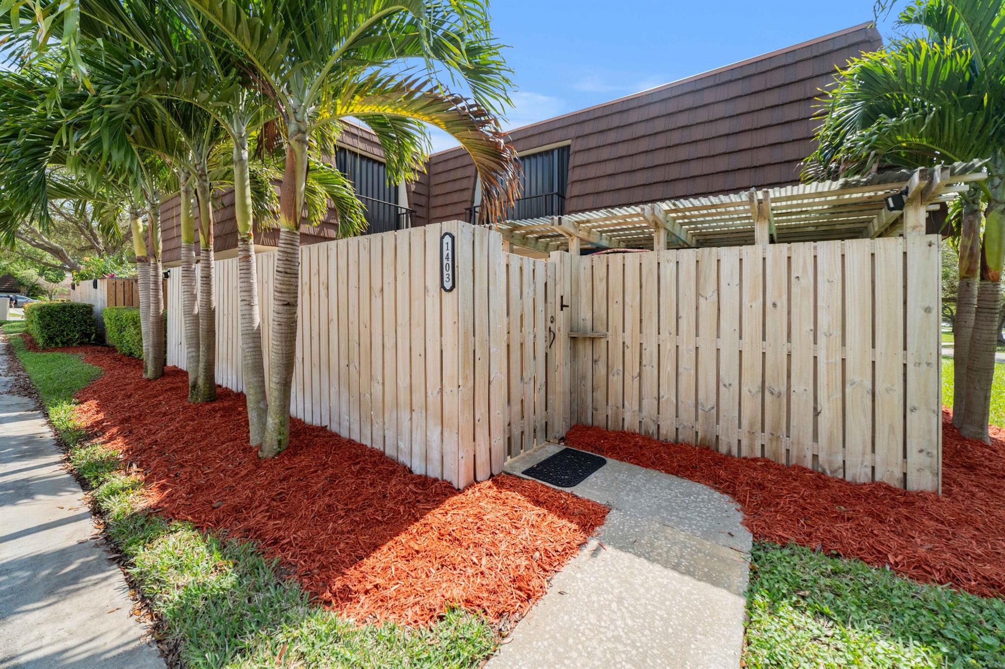 Move-in ready 2 bedroom, 2.5 bathroom townhouse with a den in Palm Beach Gardens! This versatile and quiet townhome boasts a large fenced courtyard, perfect for enjoying the Florida sunshine. Inside, you'll find an open living area ideal for entertaining, featuring a spacious living and dining area that flows seamlessly into an impressive kitchen.  A convenient half bathroom and laundry room are located downstairs, along with a den that can easily be converted into a third bedroom or home office. Upstairs, two spacious bedrooms await, including a primary suite with a large bathroom. New roof to be installed in December 2024, paid by the seller. This Palm Beach Gardens townhouse offers full impact windows and doors throughout, the perfect blend of functionality and comfort,