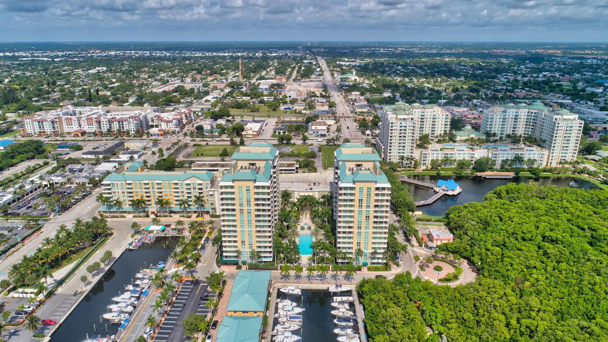 Step into your personal oasis with this remarkable 2-bedroom, 2-bathroom condo featuring an expansive wraparound balcony offering unparalleled views of the serene marina and glistening water.  Beautiful new tile in the main living area!   Equipped with conveniences like a full-size washer and dryer. This residence effortlessly combines comfort and practicality. Indulge in the lavish amenities of a five-star community, including a grand pool area perfect for soaking up the sun, an invigorating exercise room to keep you in top shape, and entertainment options like infrared sauna billiards, a theater room, and a club room for gatherings with friends and family. Conveniently nestled within walking distance of the awe-inspiring ocean