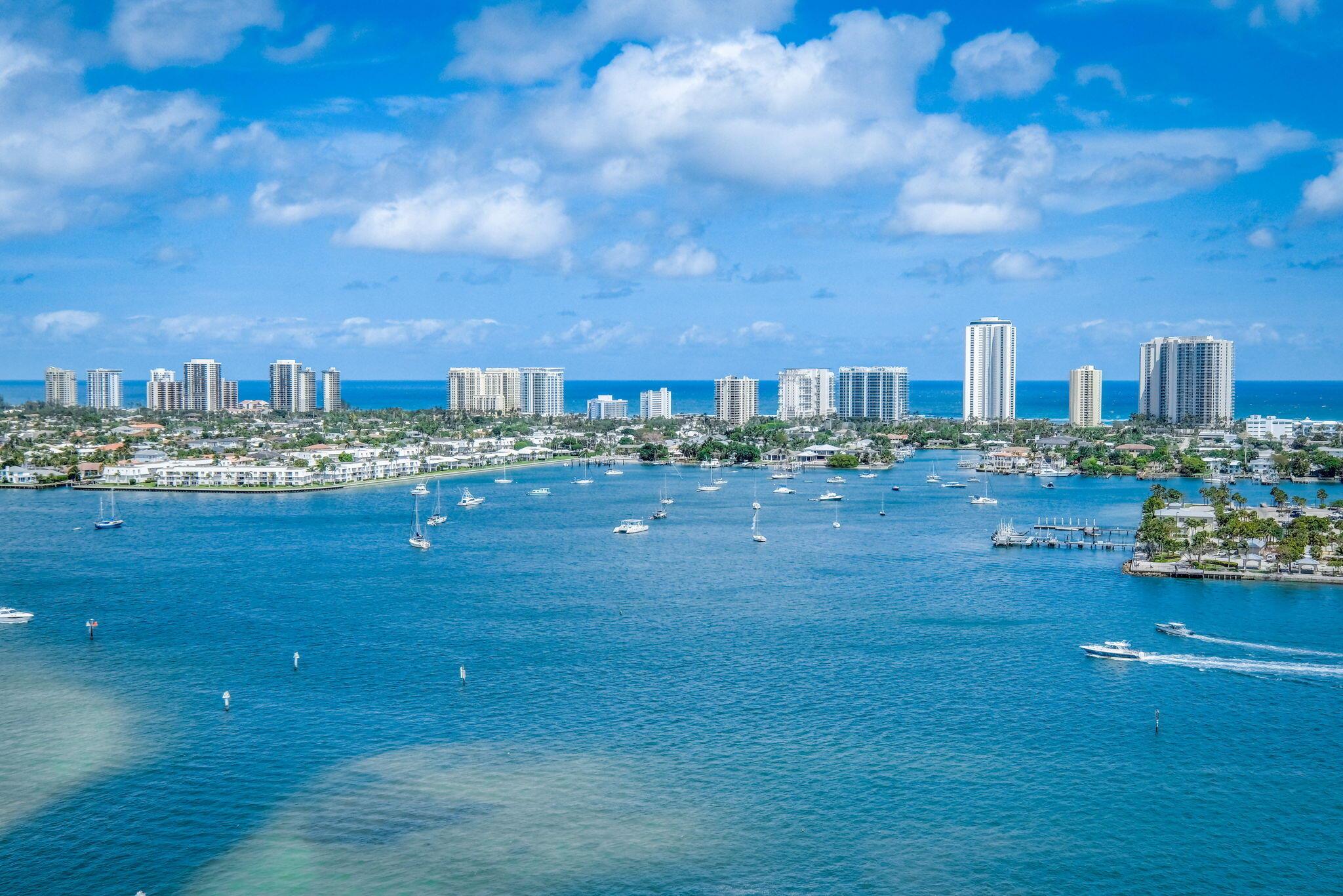 WELCOME TO COASTAL LIVING! This one-of-kind 20th floor retreat situated directly on the widest part of the pristine blue intracoastal, Atlantic Ocean, Singer Island, boating harbor and nighttime city lights. Unique 2 bd. 3 ba. home plus large den/3rd bedroom has endless upgrades, meticulously designed contemporary white kitchen with newer upgraded appliances: paneled Thermador refrigerator and dishwasher, induction cooktop, Wolf microwave, Bosch oven, extra storage, long counter height quartz island, perfect for entertaining, large master suite with 2 walk-in closets, walk out of your 9ft impact floor to ceiling sliders to enjoy morning sunrises, sea life, and boaters from your private balcony, remodeled Inside laundry room for your convenience, large1950sq.ft unit with large porcelain tile through-out (NO CARPET) and MUCH MORE! Remodeled endless resort style community amenities: roof top heated pool, whirlpool, fire place/bar for social events, sauna and steam room, grills, billiard table/ping-pong, bocci ball, 4 pickleball courts, tennis, social room, valet, manned 24hr. security, full-service marina adjacent to the property, Publix across the street and a 15-20 min. ride to PBI airport. Best FL Retreat in Palm Beach County!