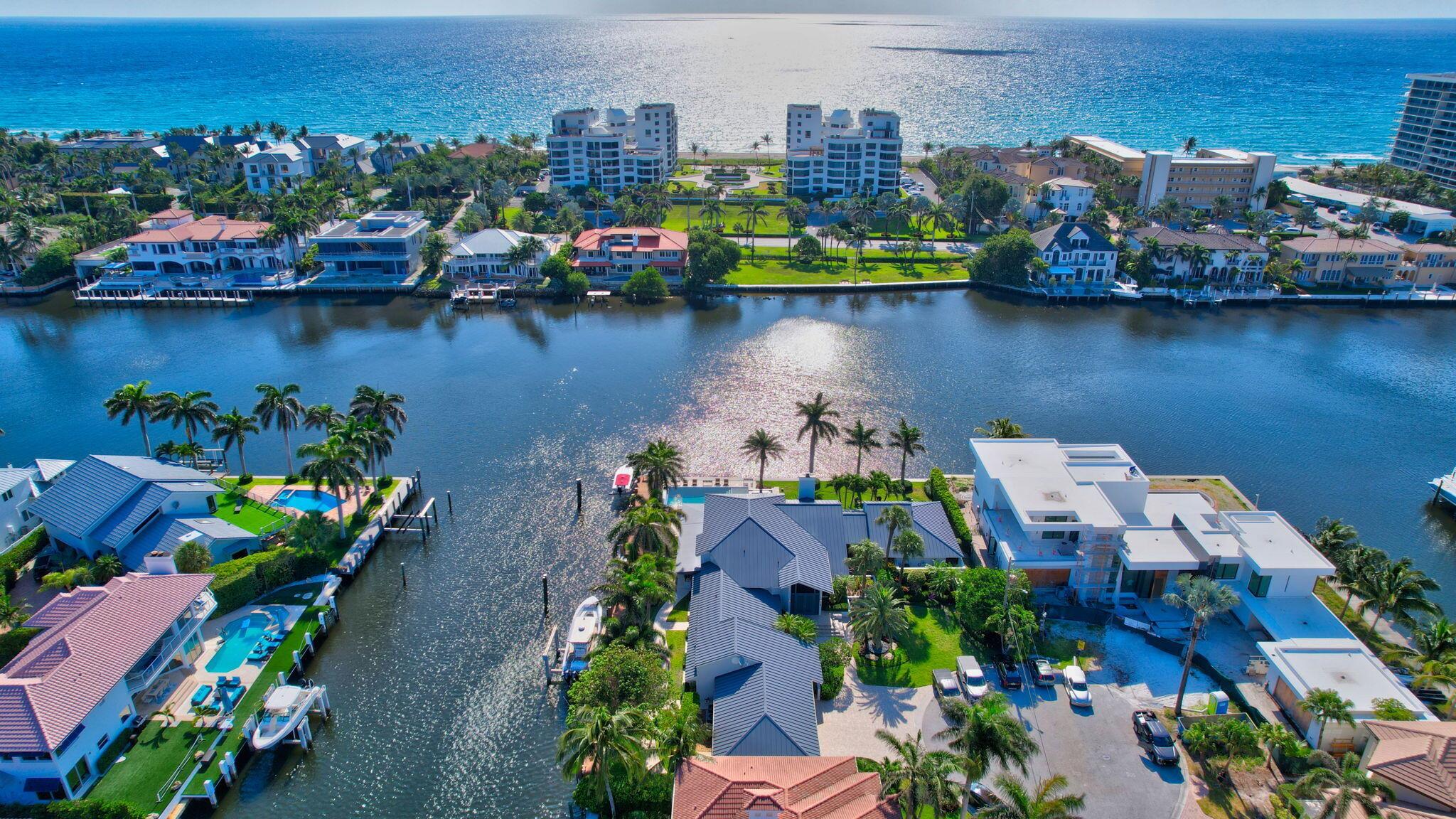 A magical modern contemporary Intracoastal point lot estate with 310 feet of deepwater frontage, including 185 feet on a side canal, this residence is a yachtsman's dream, accommodating vessels up to 150 feet. The stunning resort-style infinity pool and spa offer breathtaking views, while the meticulously crafted aluminum roof and high-voltage landscape lighting enhance the modern appeal. Inside, the fully renovated interiors feature a striking floating staircase, 9-foot solid core doors, and a master bath that exudes timeless charm. The versatile garage is newly refinished and air-conditioned, ideal for various uses.