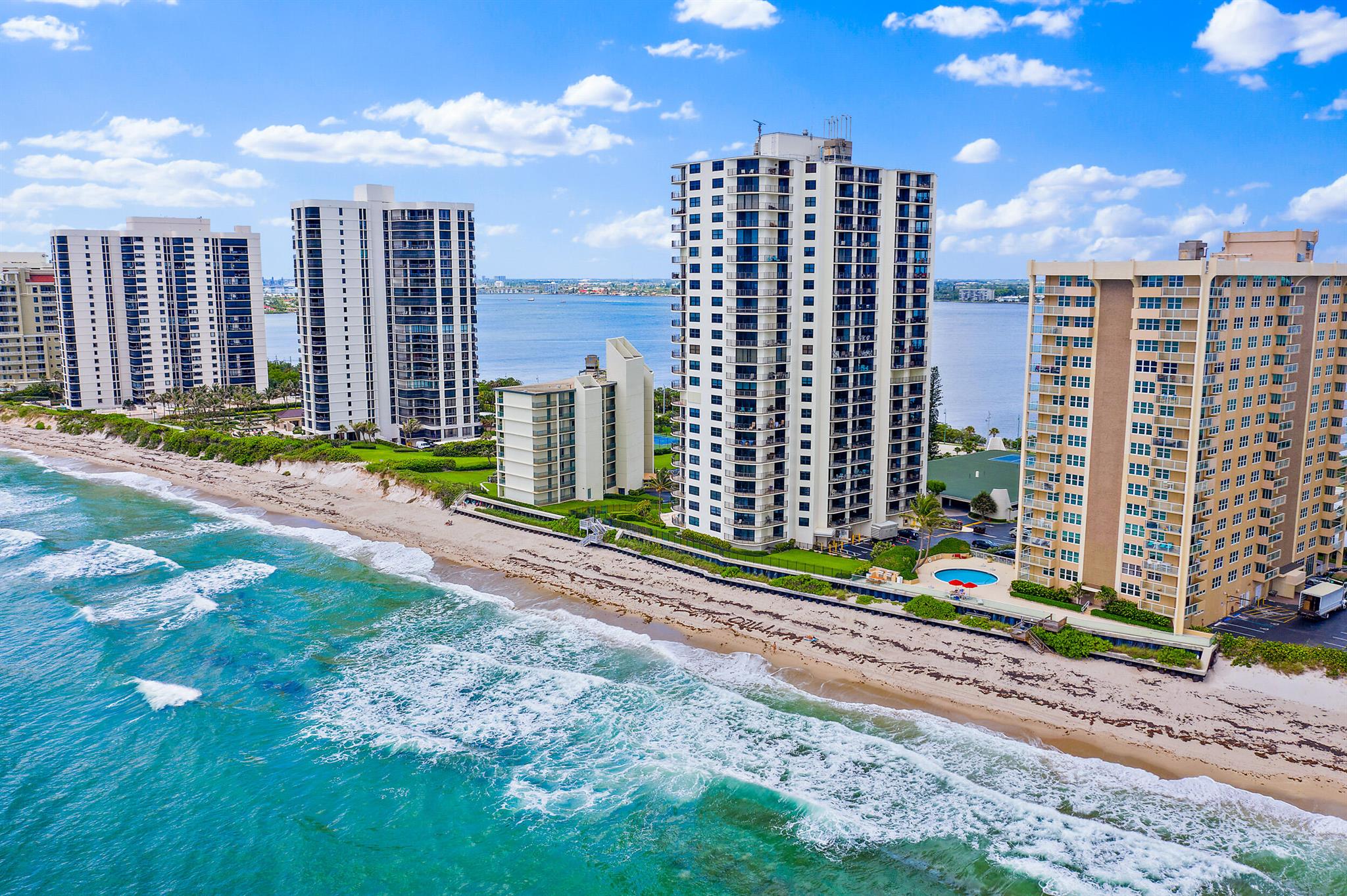 Enjoy spectacular views of the turquoise blue ocean (w/ 800' of your own private beach) to the amazing views of the Intracoastal where you can enjoy amazing sunsets & firework displays on holidays! This beautifully renovated, corner unit boasts an open floorplan & features full impact sliders & windows, (newer) furnishings, 1 assigned garage parking space, & storage! On-site Mgr. & maintenance, heated pool, BBQ, fitness center, tennis courts, & community room are just some of the amenities you can enjoy! Located on the north end of Singer Island behind your own seawall, it is conveniently located to John MacArthur State Beach Park, World-Class shopping, restaurants & anything else you can think of. THIS IS A MUST SEE!