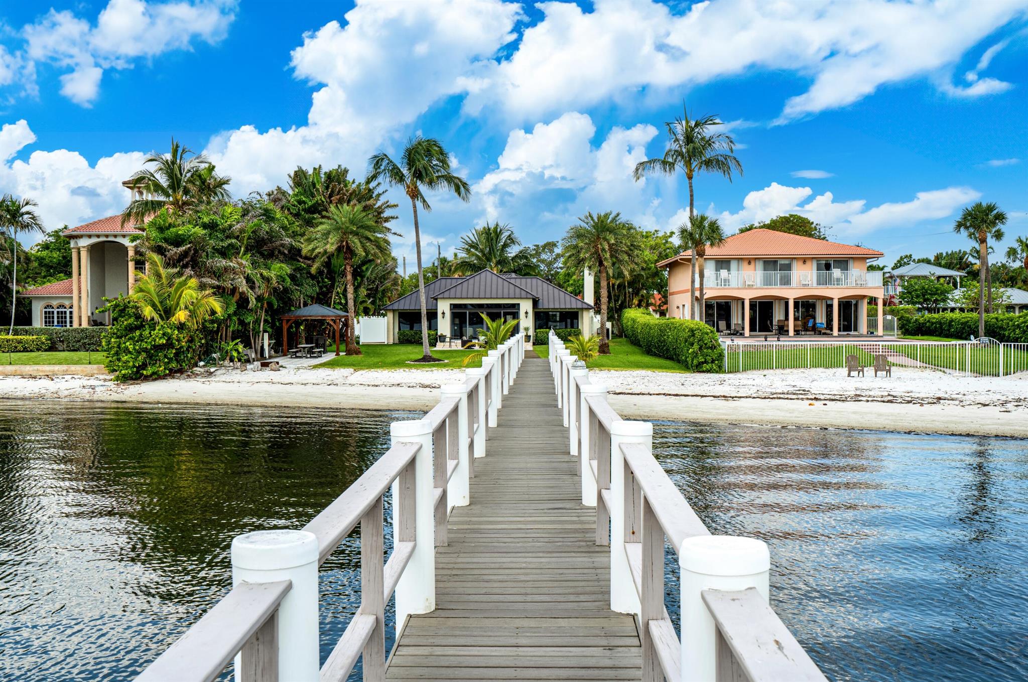 Own a piece of Old Florida paradise with this gated half-acre Bermuda-style compound with 85 feet on the Intracoastal and a 180-foot dock. Sunrises and water views are offered from all the rooms of the main updated house, and guests will enjoy the renovated guest house complete with bedroom, living room and bathroom. The information herein is deemed reliable and subject to errors, omissions or changes without notice.  The information has been derived from architectural plans or county records. Buyer should verify all measurements. 

DISCLAIMER: Information published or otherwise provided by the listing company and its representatives including but not limited to prices, measurements, square footages, lot sizes, calculations, statistics, and videos are deemed reliable but are not guaranteed and are subject to errors, omissions or changes without notice. All such information should be independently verified by any prospective purchaser or seller. Parties should perform their own due diligence to verify such information prior to a sale or listing. Listing company expressly disclaims any warranty or representation regarding such information. Prices published are either list price, sold price, and/or last asking price. The listing company participates in the Multiple Listing Service and IDX. The properties published as listed and sold are not necessarily exclusive to listing company and may be listed or have sold with other members of the Multiple Listing Service. Transactions where listing company represented both buyers and sellers are calculated as two sales. Cooperating brokers are advised that in the event of a Buyer default, no financial fee will be paid to a cooperating Broker on the Deposits retained by the Seller. No financial fee will be paid to any cooperating broker until title passes or upon actual commencement of a lease. Some affiliations may not be applicable to certain geographic areas. If your property is currently listed with another broker, please disregard any solicitation for services. Copyright 2024 by the listing company. All Rights Reserved.