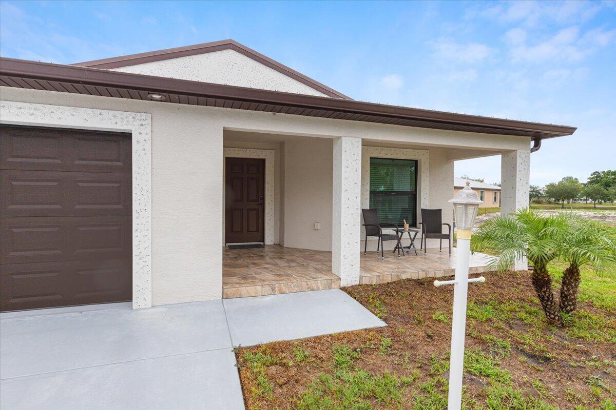 Reduced to sell!  Do not miss out on the newest and nicest resale in CCV! What a great deal!  Located on a large corner lot with freshly laid sod. Just 3 yrs old this 55+ home boasts a  metal roof , hurricane impact windows, Granite counters, shaker cabinets in the kitchen and both bathrooms, R30 insulation, exterior gutters, split floor plan with beautiful, modern laminate floors, pull down stair in attic for extra storage, large walk in closet in master bedroom along with duel sinks and walk in  shower. Privacy hedge in the rear and to top it off the furniture that is in immaculate condition is negotiable! Country Club village has so many amazing people and amenities that you will find the greatest friends that will become like family in no time!  Private golf course ( no fees to play,) Mah jong, bible study, wood workshop, golf cart parades, dinners, dances, trips and so much more! Grass cutting is also included as is trash removal. 55+ community, no HOA fees just land lease fee of $734 for  the next buyer.