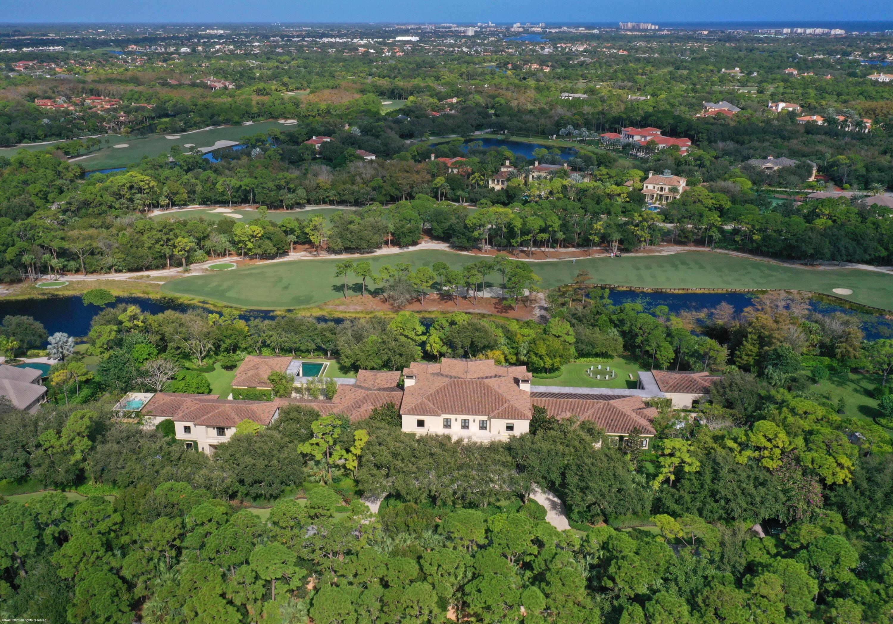 Situated on an oversized double lot in the prestigious Bear's Club located in Jupiter, Florida, this custom Palladian styled estate residence offers 33,705 total square feet with 7 bedrooms, 9 baths and 3 half baths. The property showcases views of the 11th fairway of the Nicklaus signature golf course from its expansive outdoor loggias, galleries, manicured lawn, elegant pool and spa and covered private second floor terrace. This residence was originally designed by Manuel J. Diaz and was built by Lavelle Construction in 2010. The property has been previously featured twice in Architectural Digest. The main house offers bespoke finishes and extraordinary attention to detail throughout including high ceilings and doors, custom moldings and built-ins, marble floors, beautifully proportioned rooms, a full house generator, hurricane impact doors and windows and the most spectacular master suite with a dressing room, safe room, gallery hall and a sensational bathroom that serves as a spa-like retreat. In addition to the main residence the property features a spacious free standing office conveniently located next to the master wing complete with an en-suite bath, walk-in closet and a large gym surrounded by floor-to-ceiling windows showcasing the beautiful garden and golf course views. There is also a separate two-story guest house with an office, two bedrooms and two baths, and a living room, kitchen, and laundry.