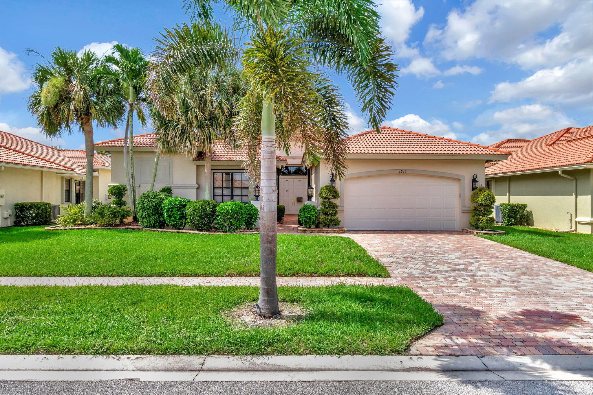 Welcome to 6963 Caviro Lane in sunny Boynton Beach, Florida, an expression of elegance and comfort. This magnificent Cabernet model in the Estate Section boasts an enchanting lake view that enhances the overall aesthetics and value of the property. Rest assured, this premium property was designed with detailed craftsmanship and high levels of luxury in mind.Entering the living area, you will appreciate the meticulous design and attention to detail. The flooring is a marvelous 1818 tile, carefully set on a diagonal. This tasteful feature enhances the sense of open space and harmonizes with the home's overall ambiance, creating an aesthetically pleasing effect. The residence is enriched with high-quality features such as upgraded granite countertops that provide outstanding durability and a sleek, polished look. The cabinets and vanities, designed for both functionality and aesthetics, elevate the feeling of luxury. It's a symphony of thoughtful detailing that endows the home with a sense of sophistication and prestige.

Importantly, for those invested in an active lifestyle and community engagement, this home is part of a vibrant 55+ community. It is more than just a home; it offers you a lifestyle. The state-of-the-art clubhouse, for example, serves as the heart of the community, offering various recreational and socialising opportunities.

For fitness enthusiasts, there's a top-notch gym, furnished with modern equipment to cater to a range of workout routines. In terms of outdoor amenities, you're equipped with well-maintained tennis courts and pickleball areas. The emphasis here is on elevating your everyday living experience, catering to both physical activity and social engagement.

Boasting supreme quality, unmatched style, and a community poised for vibrant living - 6963 Caviro Lane is more than a property; it's an experience. This is more than a place to live; it's where life unfolds with dignity, comfort, and splendor. Uncover your next chapter and seize the unique opportunity to call this gem your home.