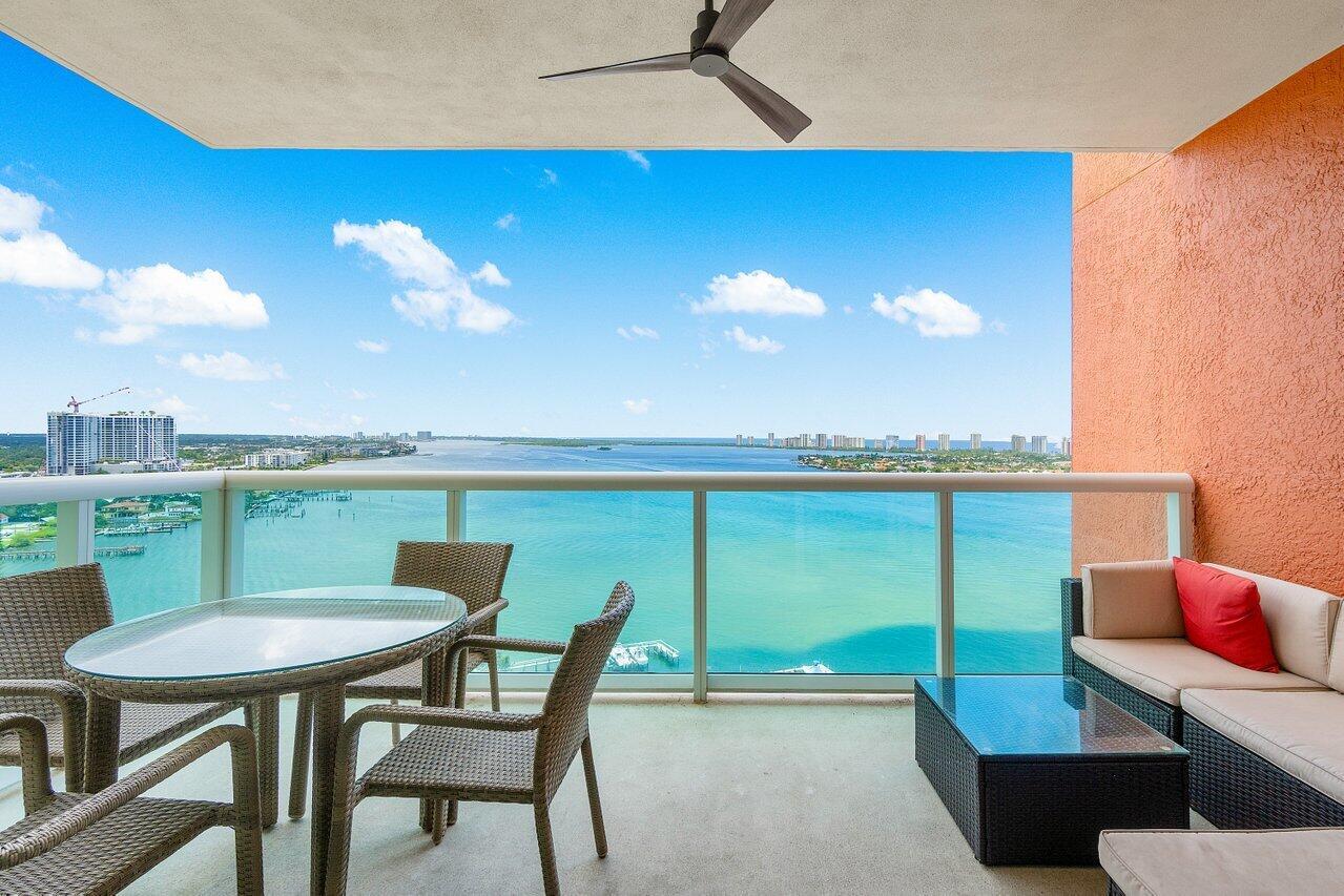 Impeccably maintained 21st floor CORNER UNIT w/2BR+den, 2BA overlooking the Intracoastal & ocean! Impact glass, semi-private elevator access. Open concept, split floor plan w/spacious owners suite w/his & her walk-in closets.  primary bathroom with large stand alone shower and walk in tub. This light and bright condo has neutral fresh paint, newer AC and newly tiled living areas! Assigned garage parking & climate-controlled storage unit. 24/7 manned gate, valet, NEW tennis, NEW pickleball, walking path w/gazebo, Newly renovated rooftop oasis w/pool, spa, BBQ areas, clubhouse, billiard room & fitness center. Marina w/dry docks available. Jump on your boat effortlessly & be on the ocean in minutes; no fixed bridges! Pet friendly & social communitity