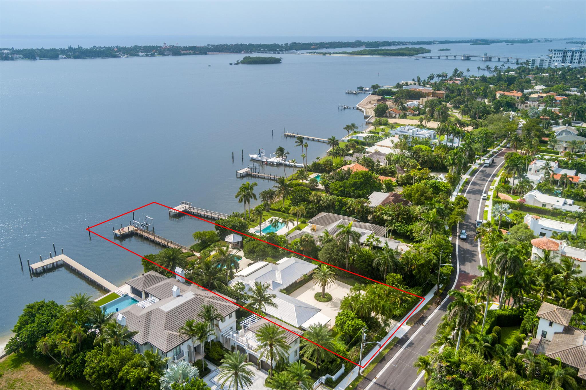 Rarely available and highly desirable, This is an opportunity to own a truly unique waterfront home in the highly sought-after Prospect Park neighborhood of West Palm Beach. With its prime location and breathtaking views, this property provides limitless potential for creating your dream home. This half acre property offers unparalleled privacy and exclusivity, featuring a direct-access boat dock with a lift, all within a private, gated setting. The non-landmarked charming 3-bedroom, 2-bathroom ranch-style home provides an open-concept living and dining, complemented by an expansive heated pool, integrated hot tub, and beautifully landscaped patio. Move in ready or build your dream home! 2916 Washington Road is on a private stretch off of South Flagler and is walking distance to all WPB has to offer.  There is no road between the dock and the home - truly a rare find - approximately 30 lots like this exist in all of WPB.  The gorgeous views stretch from key Palm Beach landmarks, The Breakers hotel and Mar-A-Lago club, with direct sunrise and the sunset reflects on all of the white Palm Beach mansions across the Inter-coastal.  Hard to find a better view in the area in WPB or Palm Beach - only beautiful mansions, yachts riding by and glistening water - no high rises, no marinas, no moored boats, no commercial structures...

If you are looking for an investment project, you have found your Holy Grail.  West Palm Beach has become the most desirable market in Florida for developers.  Unlike other homes nearby, this home is not landmarked.  If you desire, the potential to develop this lot into a 8000 sqft + dream home exists.  Soil testing, sea-wall inspection and survey has just been completed and all has come back with positive results to develop a legacy home. All of these documents are available to review.  You only have to look next door at 2914 Washington to see the potential of what can be built on this lot. 

2916 is currently leased for $25,000 a month - there is potential for this to continue if the buyer is interested in collecting revenue while finalizing plans and permits for a new build.  The existing home is charming as is with terra cotta floors, pink stucco and metal roof.  And it's truly about the most important thing in real estate: location, location, location!!