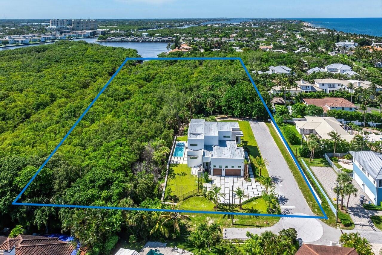 This is ones-in-a-lifetime opportunity to own a total of 4.92 acres in Ocean Ridge, including 1.32 acres of buildable land. This exclusive new construction is ready to move in!! Just two houses away from the beach with access reserved exclusively for residents. Nestled on a private street, this stunning 5-bedroom, 5.5-bathroom home offers a seamless blend of luxury and comfort. Step through the double-height ceiling foyer into an open concept layout with a climate-controlled glass wine cellar, perfect for showcasing your collection. The great room features custom slated Brazilian wood wall cladding, setting the stage for cozy gatherings. Lot is big enough to build a second home. Some images have been virtually staged to better showcase the true potential of rooms and spaces in the home.