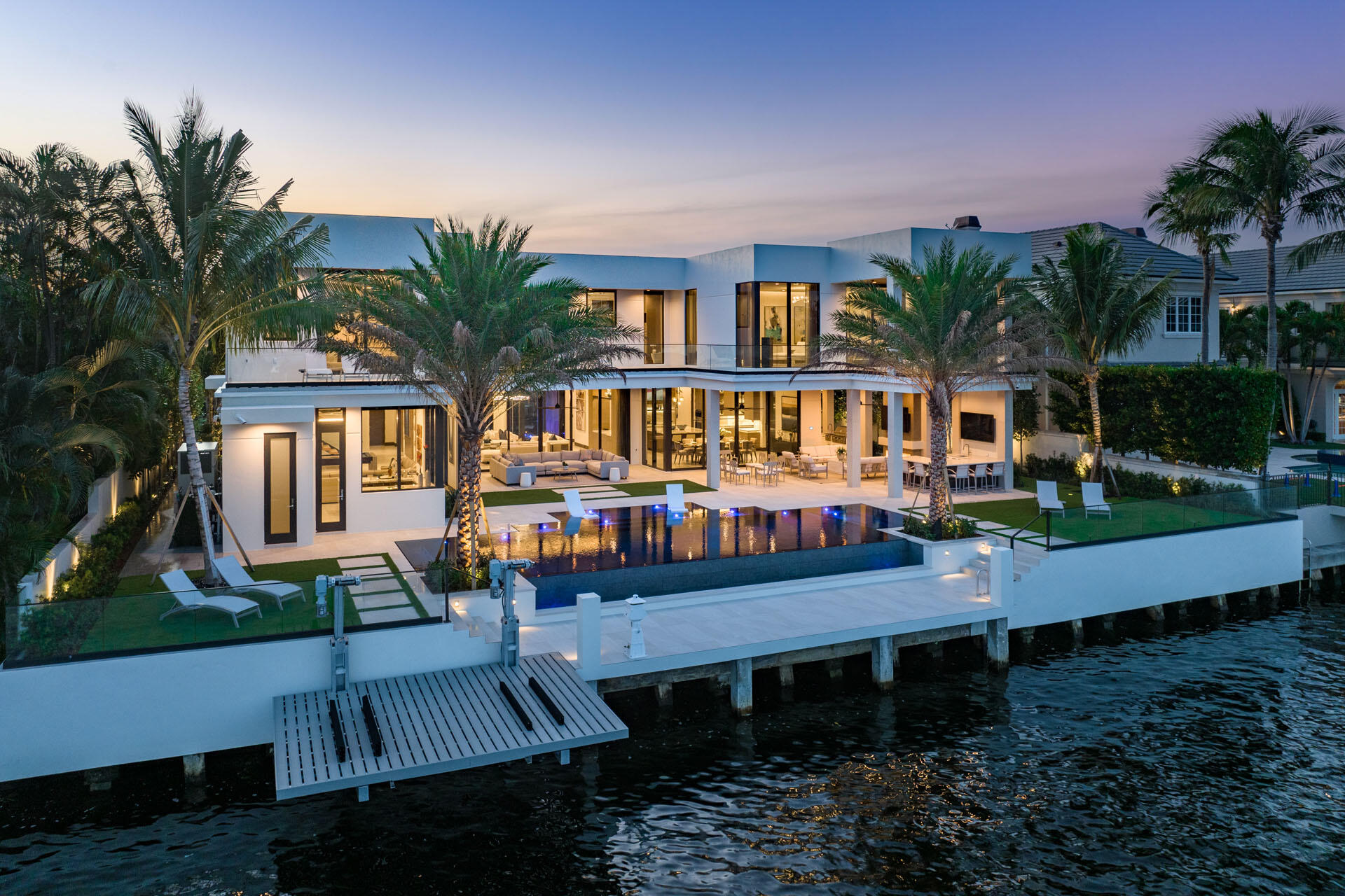 Elevate your lifestyle with this amazing turn-key Signature Estate by SRD Building Corp, setting the standard for elite Intracoastal living. Built in 2022, this exquisite residence is over 8,200 square feet of open, airy living space. The five-bedroom masterpiece offers a 4-car plus golf cart garage, resort-grade pool and backyard amenities, and 100 feet of prime Intracoastal frontage complete with a private dock and Jet Ski Lift. Experience unparalleled sophistication with full-house automation via the Crestron smart-home system, a cutting-edge security system, and meticulous craftsmanship only SRD can deliver. Fully furnished by the award-winning P&H Interiors design group, this Intracoastal gem is a true haven of luxury.