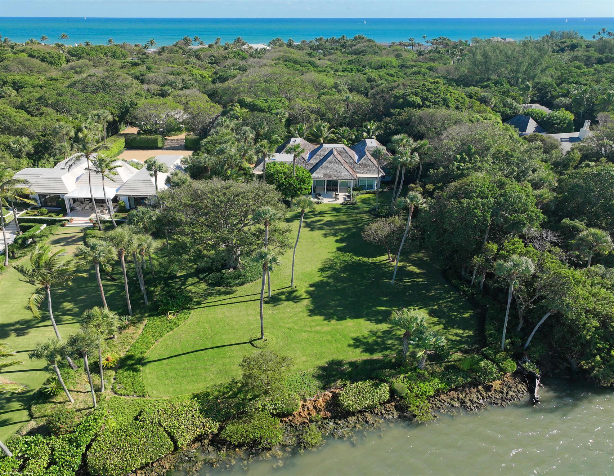 Enter down a long private drive to 286 S Beach Rd. a newly renovated Jupiter Island Intracoastal property on almost 3 acres with wide water, undisturbed views across to a natural sanctuary. There is DEEDED OCEAN ACCESS directly across the street to a secluded, pristine beach. The 4,233 sq ft main includes 5 bedrooms and 4.5 baths. In addition, a 3 bedroom guest house, each with its own bath plus a large living/dining area, full kitchen and laundry provides ample space for extended family and guests. Jupiter Island Building regulations allow for increased floor area up to an additional 7,900 sq. ft. to the existing structures or further construction of accessory buildings. Room for a pool and dock.