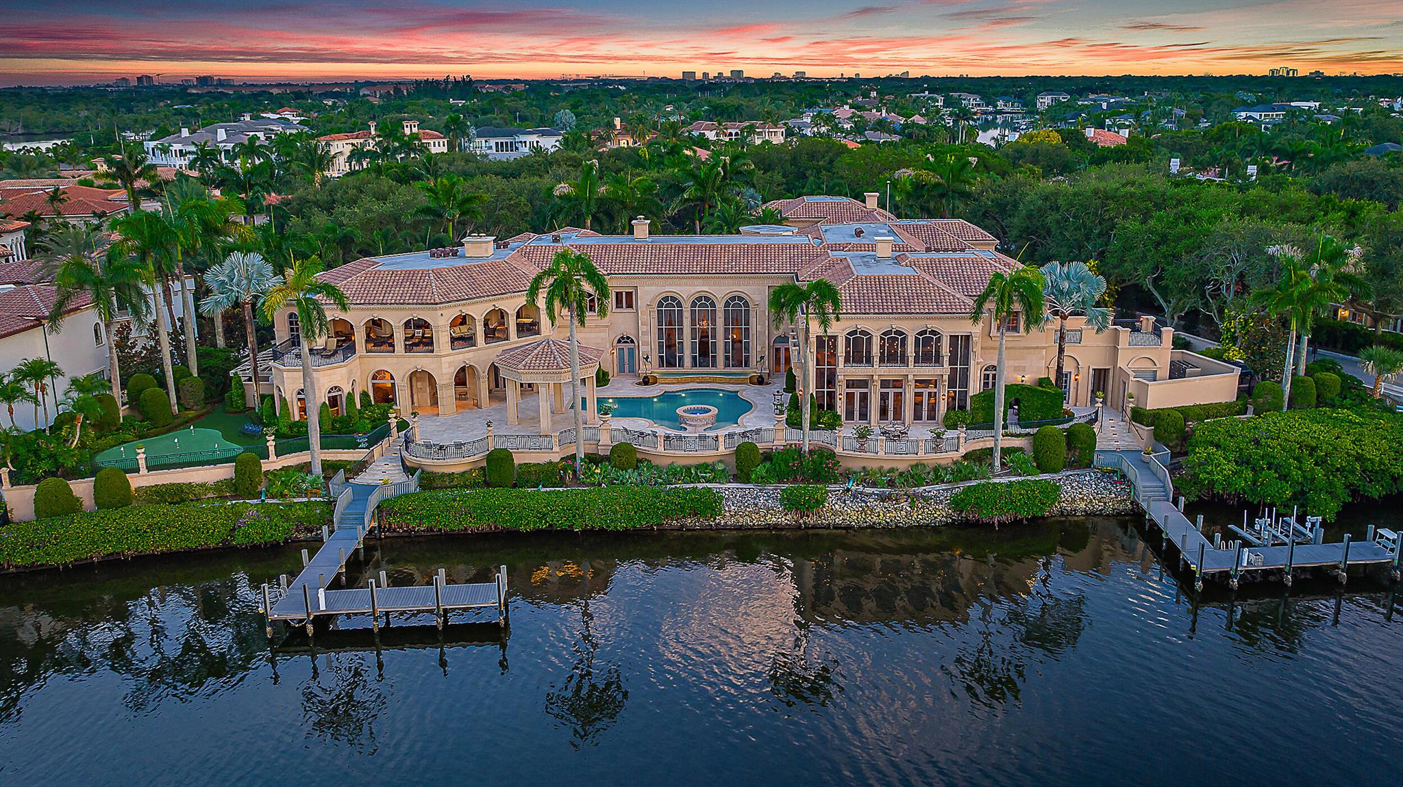 Welcome to this palatial estate in the prestigious Admirals Cove, offering an unparalleled blend of luxury and serenity on the Intracoastal. Boasting an expansive 300 feet of prime waterfrontage, this masterpiece of design and craftsmanship features 9 grand bedrooms and 13 lavish baths, providing ample space for both relaxation and entertainment. The timeless interior exudes sophistication, with each room meticulously crafted to reflect elegance and comfort. The estate includes a separate 3-bedroom guest house, perfect for hosting visitors while ensuring privacy. For car enthusiasts, a 6-car garage offers abundant storage and security.Outdoor living is elevated with two private docks, ideal for accommodating large yachts or multiple watercraft.