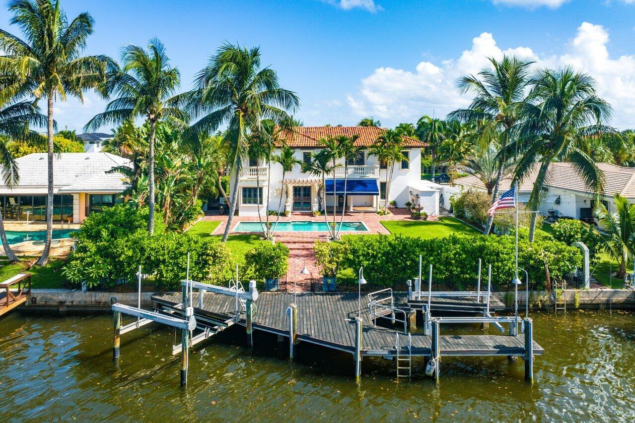 Experience unparalleled elegance & exclusivity in the prestigious College Park neighborhood of Lake Worth Beach. This exquisite custom-built Mediterranean estate, offers 5 bedrooms and 4.1 bathrooms, epitomizing refined Florida living. Second staircase features an Electric chair lift with easy access to the upstairs. Behind a private gate, you'll find a residence adorned with sophisticated touches and premium amenities. Indulge in the heated and cooled saltwater pool or take advantage of the dock equipped with dual lifts, providing effortless access to the Intracoastal. The home boasts a chef's kitchen, huge island, impact windows, custom doors from Mexico, whole-house generator & soaring-high ceiling. The main suite is a serene retreat, every corner of this property exudes luxury & style