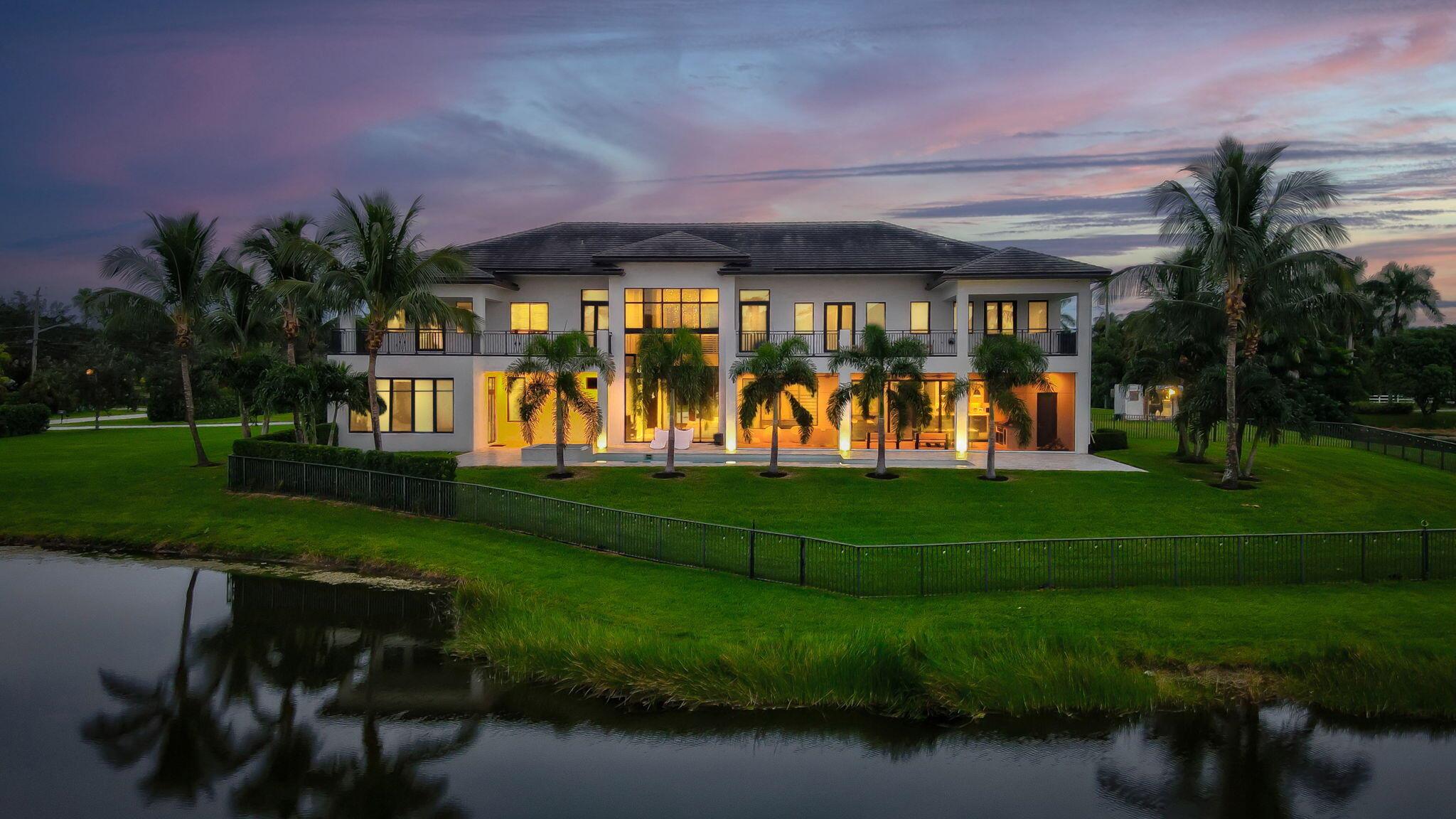 This true estate on 5.66 acres features dramatic lakefront views within the private gated community of only 78 homes.  As a transitionally modern designed residence, it features a two story main entry, foyer and main living room, with soaring floor to ceiling glass windows.  A billiard area, family/ media area, dual island full kitchen, bar area, a primary suite with dual bathrooms and secondary bedroom suite complete the first floor level interior. A 45 foot covered patio with winter kitchen, an open heated pool with spa complete the exterior.  The secondary level consists of four full bedroom suites, three of which open to spacious open and covered patios, and a media/ club room. A grand circular driveway, four car garage and lush landscaping offer total privacy.  See MORE ... Additional downstairs bedroom as well as upstairs and downstairs laundry rooms. Upstairs bedroom suites have direct access to an expansive patio terrace with French doors. Ideal entertaining spaces from the upstairs balconies to the pool, automatic screens and cabana bath. Yard is fully fenced in with mature landscaping hedge along the property line. House features all impact windows and a Kohler generator. 

Additional House Details: 
Driveway - gray paver circular
4 car garage plus
5.6 acres
Concrete tile
Waterfrontage
Mature landscaping
Fenced in
Impact windows - full
Built in sound speakers
Private
Septic - county water
A/C - 4
2 propane tanks
Kohler generator

Pool: 35 x 12
With sun shelf 7 x 10
Gas heater
Aqua link
Jandy pool heater
Pool and spa air blower
Spa 6 x 5
4 patio uplighting
Cabana bath
Shower
Patio
Tumbled marble floor
Automated screened in patio
Ruby series gas grill
Outdoor kitchen - summer
Pool sun shelf

Foyer: 
Glass front door
Floor to ceiling glass
25 ft high covered entrance veranda

Great room 18 x 20
30 ft ceiling
Floor to ceiling glass
Porcelain flooring 30 x 30
Fireplace - gas, ventless
Powder room
Storage closets throughout.
Staircase stainless steel railings
Wood steps

Primary suite: 25 x 20
Hardwood floors
North and west windows with access to pool patio
Dual walk-in closets with custom built ins
Walk in closet 25 x 14
Dual primary bathrooms
1st bathroom 13 x 13
2nd bathroom 12 x 7
Porcelain floors
Frameless shower
Separate tub
Water closet
Vanity
Sitting area

Billard area
Dining room 14 x 15
Family room 21 x 22
Overlooking pool area
Kitchen 13 x 21
Quartz counter top - waterfall
Dual islands
Under counter storage
Thermador gas 6 burner and grill
Wall oven
Bosch coffee maker
Wood veneer cabinets
Poly textured cabinets
Walk in pantry - with build out custom 8 x 10
Thermador wall microwave
Thermador Beverage drawer refrigerator
Thermador

Guest room suite 16 x 14
With walk in closet and custom closet
Ground floor

Laundry room - upstairs and downstairs
Samsung washer and dryer
Sink and marble countertops
Cabinets

Upstairs powder bathroom
Upstairs - 2nd floor
Access to balcony - open and covered
Hardwood floors throughout
North side balcony with access

Media room -office
VIP Suite 17 x 14
VIP Suite bathroom 15 x 9
Bedroom #3 21 x 17
Bedroom #2 20 x 16
With access to balcony
Lot size 345 x 715 x 340 x 715