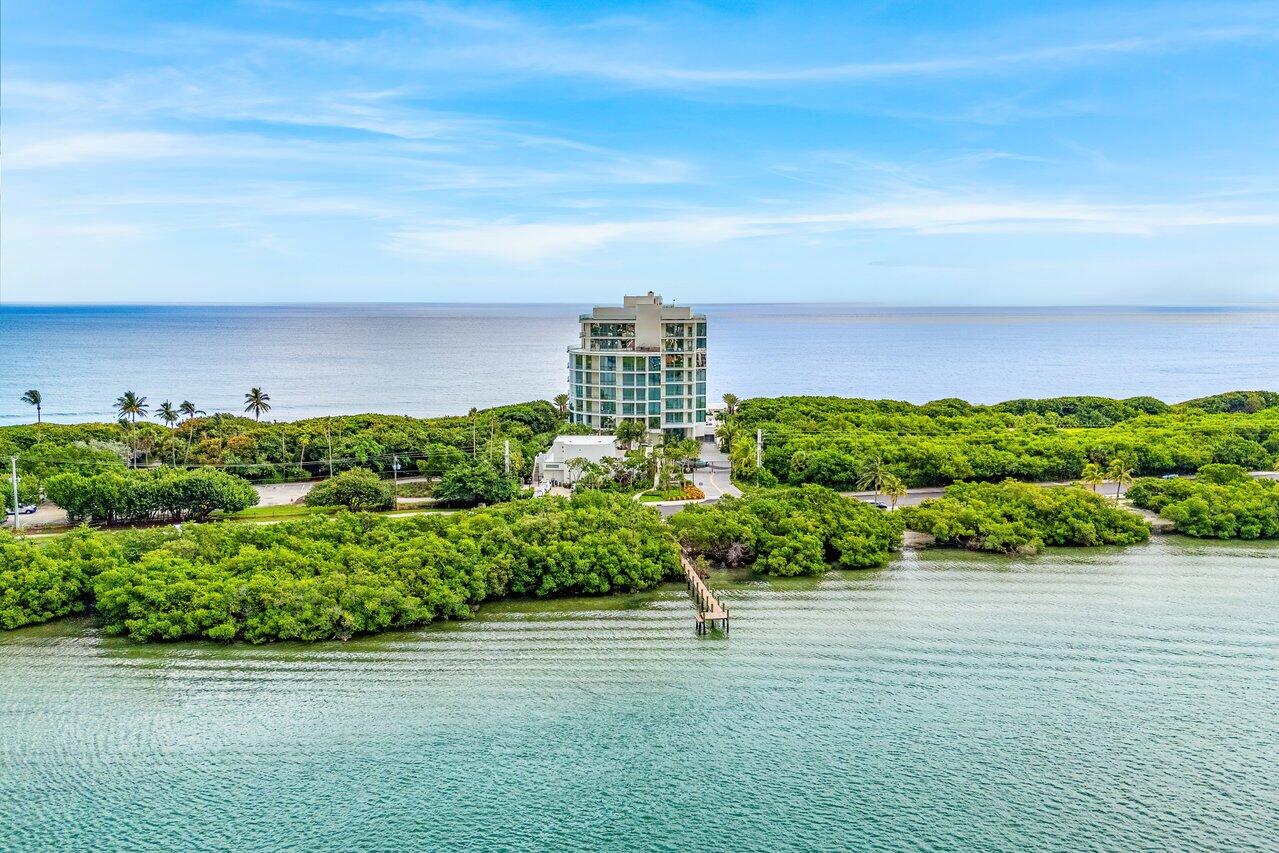 Brand New Construction direct ocean with intracoastal views and day dock at Seaglass, Jupiter Island is now offered at an incredible value! This building is the only move in now new construction available on Jupiter Island.  Sited among protected lush landscaping, this exclusive 21 residence building is complete with world class luxury amenities to include a private gate entrance, ocean front infinity - edge heated pool, beachside chaise lounges, summer kitchen, heated spa, full - time property manager, fitness centre, yoga meditation lawn, club room with catering kitchen and game area, Outdoor fire pit and BBQ along with a dog walking area and bathing station! This 3-bedroom, 4.5-bathroom condo spans 4,365 square feet of modern elegance with 10ft high ceilings and beautiful natural light throughout.  Step from your private elevator into a bright, open floor plan with floor-to-ceiling windows showcasing stunning ocean and Intracoastal views. The gourmet kitchen features custom cabinetry, dual Miele dishwashers, a gas range, and double ovens, all set against sleek porcelain flooring. The primary suite offers his and her bathrooms with walk in closets. Enjoy your private balcony with a summer kitchen overlooking the ocean and intracoastal. Two climate-controlled garage spaces in this exclusive 21-unit residence with minutes to the airport, world class shopping, dining and recreation. This is South Florida living at its finest!