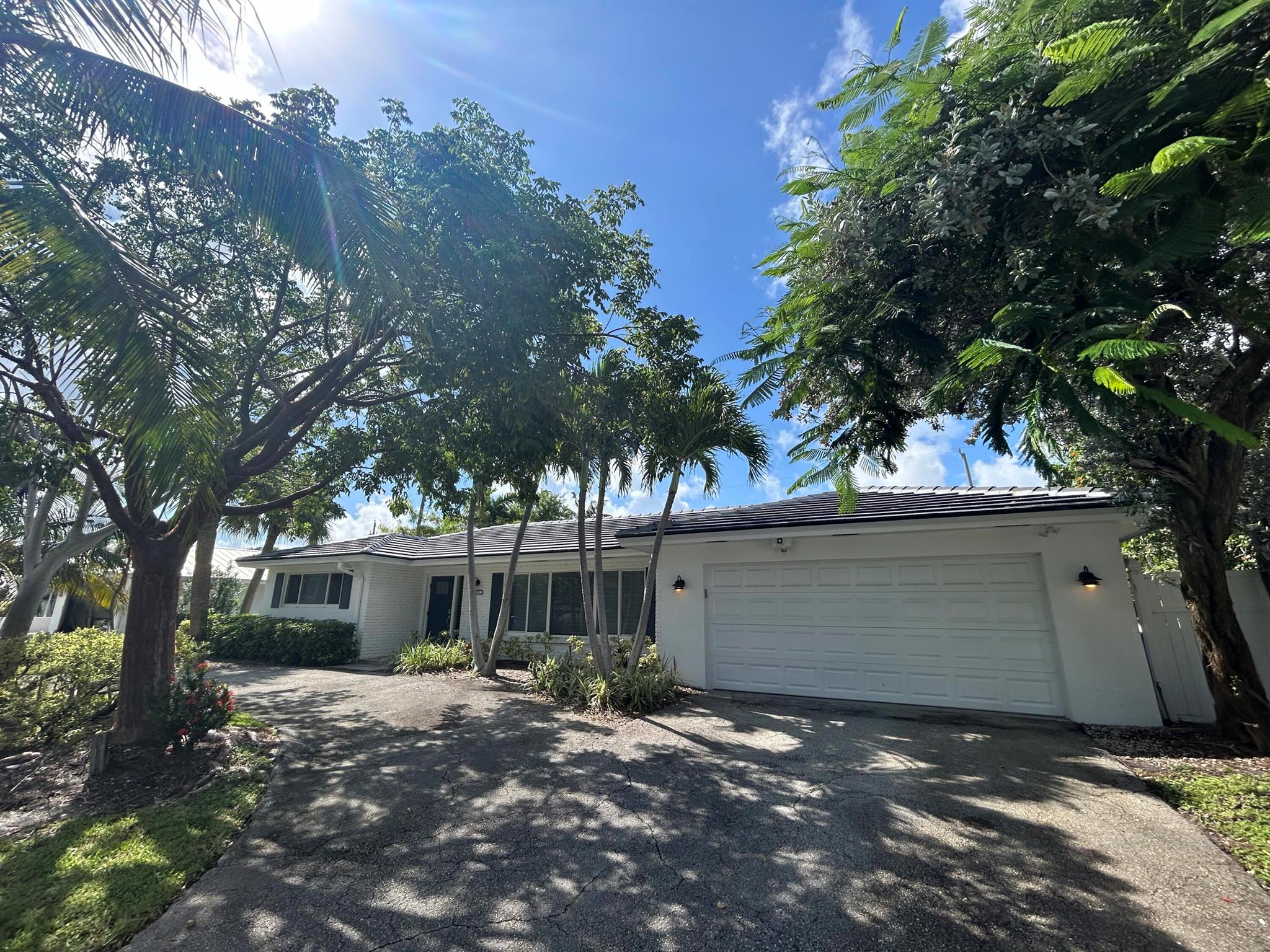 New 50-year tile roof.  5-star renovations, open floor plan, gourmet kitchen with stainless steel appliances, key west style cabinetry, large island that doubles as a bar.  Pass through into the enclosed Florida room off the heated pool with 3 impact glass sliders.  Perfect for entertaining.   Screened in patio with multiple sitting areas and beautiful pool fountain giving the pool area a spa like experience.   Cabana bath off the master bedroom leads to upgraded dual sinks and a stand-up shower.   Oversized master bedroom, split floor plan. The 2nd and 3rd bedrooms located near the guest bath. Includes a 6-seat golf cart for a short ride to the beach at the end of the street. Garage has A/C to keep cars cool, not included in living sq footage. Mins from restaurants, snorkeling and beach!