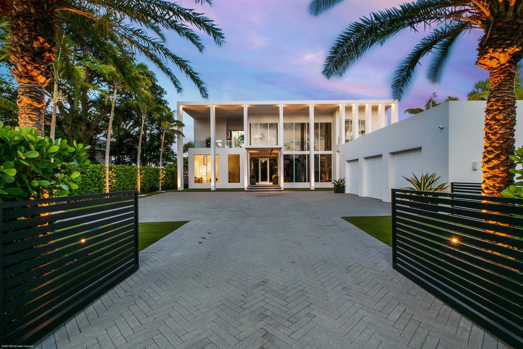 Nestled in prestigious Palm Beach Gardens, this stunning single-family home epitomizes luxury living with its gorgeous water views and ultra-modern design. Boasting a prime location, every aspect of this residence exudes elegance and comfort.Upon entering, you are greeted by an expansive foyer that leads seamlessly into the spacious living areas. The interiors are adorned with high-end finishes, including large format tile floors, custom Bizassa tiled bathrooms, designer light fixtures, and soaring windows and glass doors, creating an ambiance of sophistication with unobstructed views. The gourmet kitchen is a chef's dream, featuring state-of-the-art appliances, sleek cabinetry, and a center island perfect for culinary creations or casual gatherings. Adjacent, the dining area offers panoramic views of the waterfront, setting the stage for memorable meals with family and friends.
The primary suite is a sanctuary of relaxation, complete with an expansive private terrace overlooking the serene waterways, a luxurious European designed en-suite bathroom with a generous soaking tub, grand walk-in shower with rain showerhead, dual vanities, and ample closet space for ultimate convenience.
Outside, the expansive lanai and heated pool area provide an ideal setting for outdoor living and entertainment. Enjoy breathtaking views from the infinity-edge pool, host a family BBQ at the outdoor summer kitchen with seamless access to the interior kitchen, or unwind at the firepit table while soaking in the picturesque surroundings.
The VIP guest suite, or second primary bedroom, is generously spacious, featuring a layout that exudes both privacy and openness. The floor to ceiling windows and sliding glass doors allows for panoramic views of the waterway and offer an enormous amount of natural light with direct access to the private covered lanai. Boasting a spa-like European style en-suite bathroom, spacious walk-in shower with rainfall showerhead, dual vanities with ample counter space and storage cabinets are seamlessly integrated into the design. The thoughtfully designed walk-in closet can accommodate both short-term and long-term stays. It features custom shelving, drawers, and hanging space for clothing and personal items, ensuring guests feel at home during their stay.
Additional highlights of this exclusive residence include a private deck for basking in the South Florida warmth, a wine cellar for connoisseurs, a media room for cozy movie nights, state-of-the-art home technology with built in sound system- all controlled from the convenience of your ipad or cell phone, a meticulously kept oversized 3-car garage that is climate controlled and features sufficient storage. Fragrant herbs flourish in the personal herb garden at the front of the estate.
Located in one of South Florida's most coveted areas, you will enjoy easy access to fine dining, shopping, and entertainment options, as well as proximity to pristine beaches and world-class golf courses.