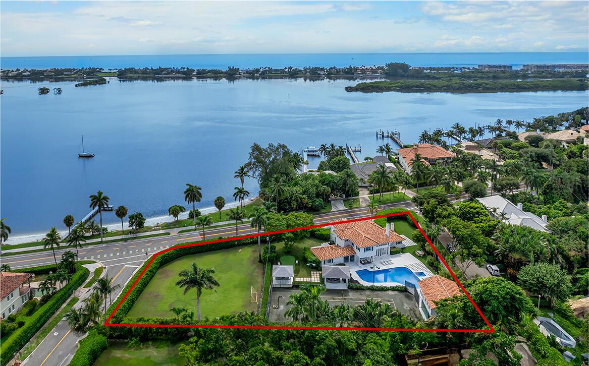 Exceptionally rare 282 feet of frontage on S. Flagler Dr. in SOSO- two parcels offered together. Properties span a block making this the largest available waterfront property in West Palm Beach.  Over an Acre of land for a family compound with a newly renovated home, guesthouse with kitchen and water views, 40 ft long pool with spa, clay-lit tennis court with tiki hut seats 14 and outdoor marble bar seats 14, putting green and detached apartment for staff with kitchen.  The North parcel has unobstructed water views across the wide intracoastal.  Parcels are subdivideable into 3 lots.Six total bedrooms including a master on each floor with marble bathrooms with double sinks, large closets & large windows.  Upstairs master with balcony and waterviews.  Rare one of a kind family compound