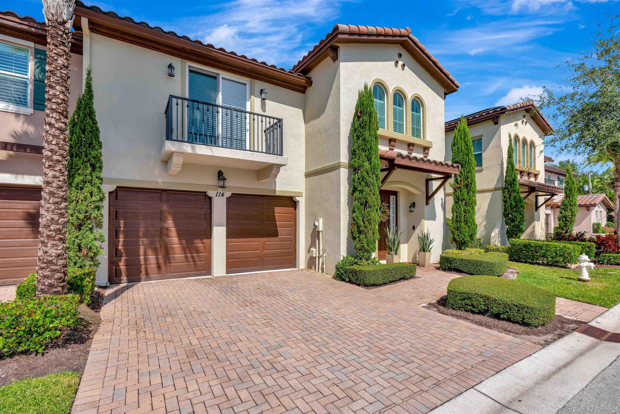 Discover this exquisite three-bedroom, 2.5-bath townhome, perfectly situated in the heart of Jupiter. Featuring a spacious two-car garage and an expansive loft on the second floor, this home combines elegance with functionality. Step into a gourmet kitchen adorned with custom wood cabinetry, quartz countertops, and a striking tile backsplash, all complemented by top-of-the-line GE appliances, including a double oven. The primary suite, conveniently located on the first floor, boasts a luxurious master bath complete with a walk-in shower and soaking tub. Upstairs, the second floor offers a versatile loft area, alongside two guest bedrooms sharing a well-appointed Jack and Jill bathroom. The home is equipped with impact glass and doors throughout, ensuring both security and peace of mind.