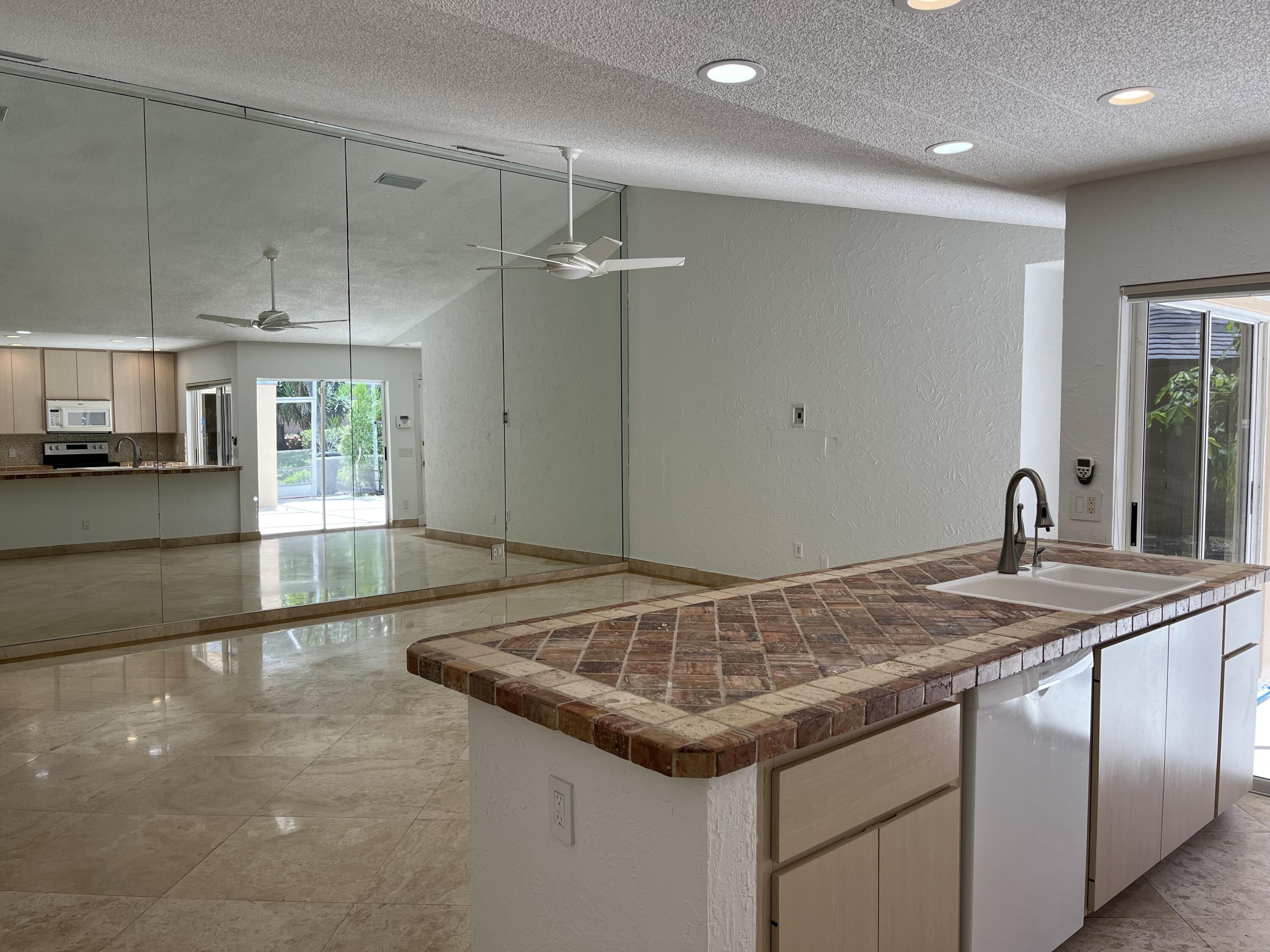Fabulous single story townhome in excellent condition in the heart of Palm Beach Gardens. Owner is a tile contractor; you can enjoy the benefits of his quality and labor. Excellent condition - marble floors throughout main living areas, high quality luxury vinyal plank flooring in bedrooms, updated baths. New AC. Private screened patio for indoor/outdoor living. Low HOA fees include building insurance and roof, no outstanding assessments. Community pool. Easy to see