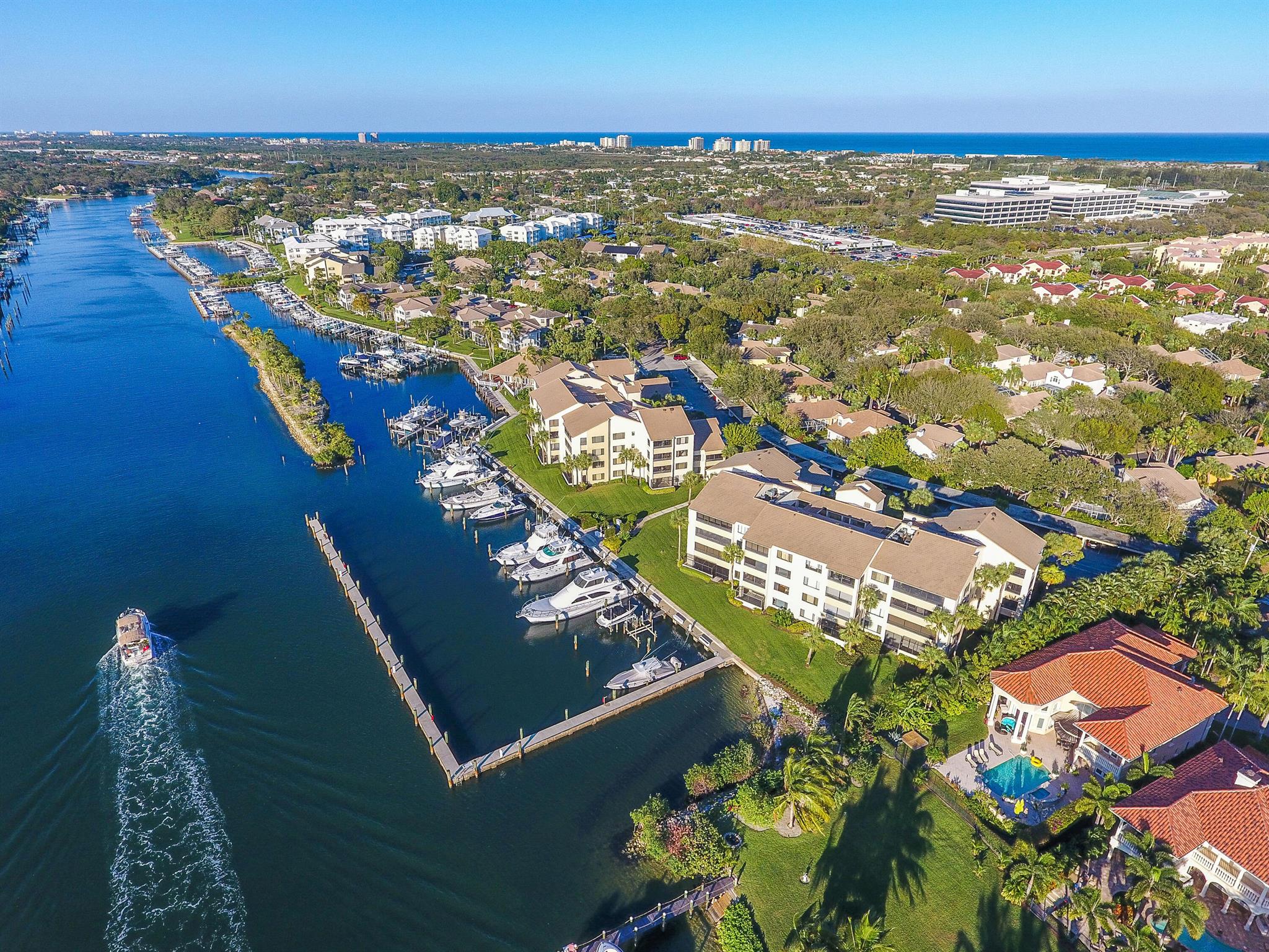 Experience waterfront living in this light and bright 2 bed and 2 bath corner unit with lanai. This condo is ideally located within the Oak Harbour community directly across from tennis and pool, and is in close proximity to all that South Florida has to offer. This is a full amenity community, featuring pool, tennis, gym, clubhouse, all which is located directly on the intracoastal. PBI is just a 20 minute drive.