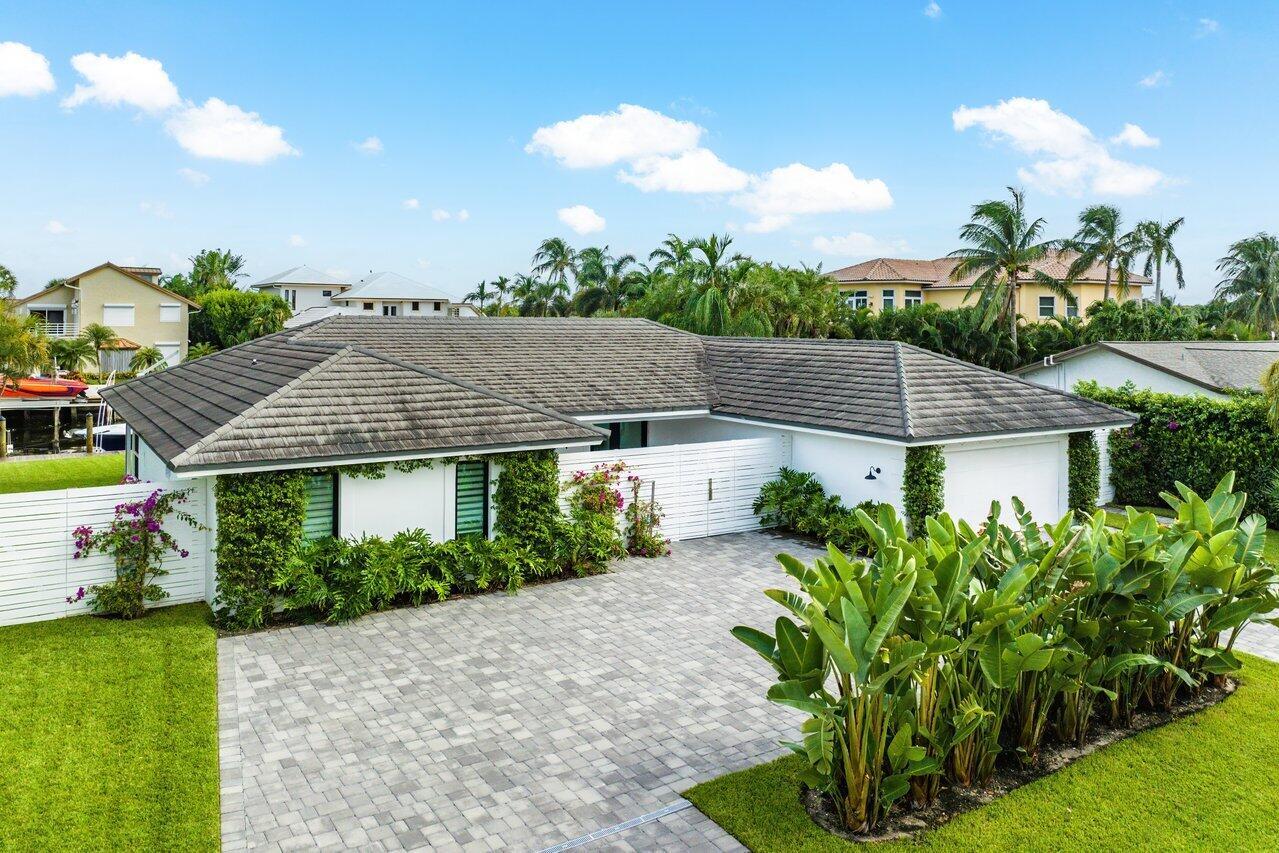 Bring your 65' boat and bathing suit!  This exceptionally renovated 3 bedroom, 2.5 bath waterfront home in the charming community of Ocean Ridge has 100' of water frontage on a navigable canal, a new dock with electric and water, deeded beach access, screened outdoor patio and pool.  Completely renovated in 2021, it boasts new impact windows and doors, hardwood flooring, cabinets, kitchen appliances, bathrooms, pavers and landscaping.  Stove can be converted to gas.  Perfect home for an avid boater with super close access to the inlet, yet protective canal location.  Don't miss this opportunity for a waterfront home on the barrier island.