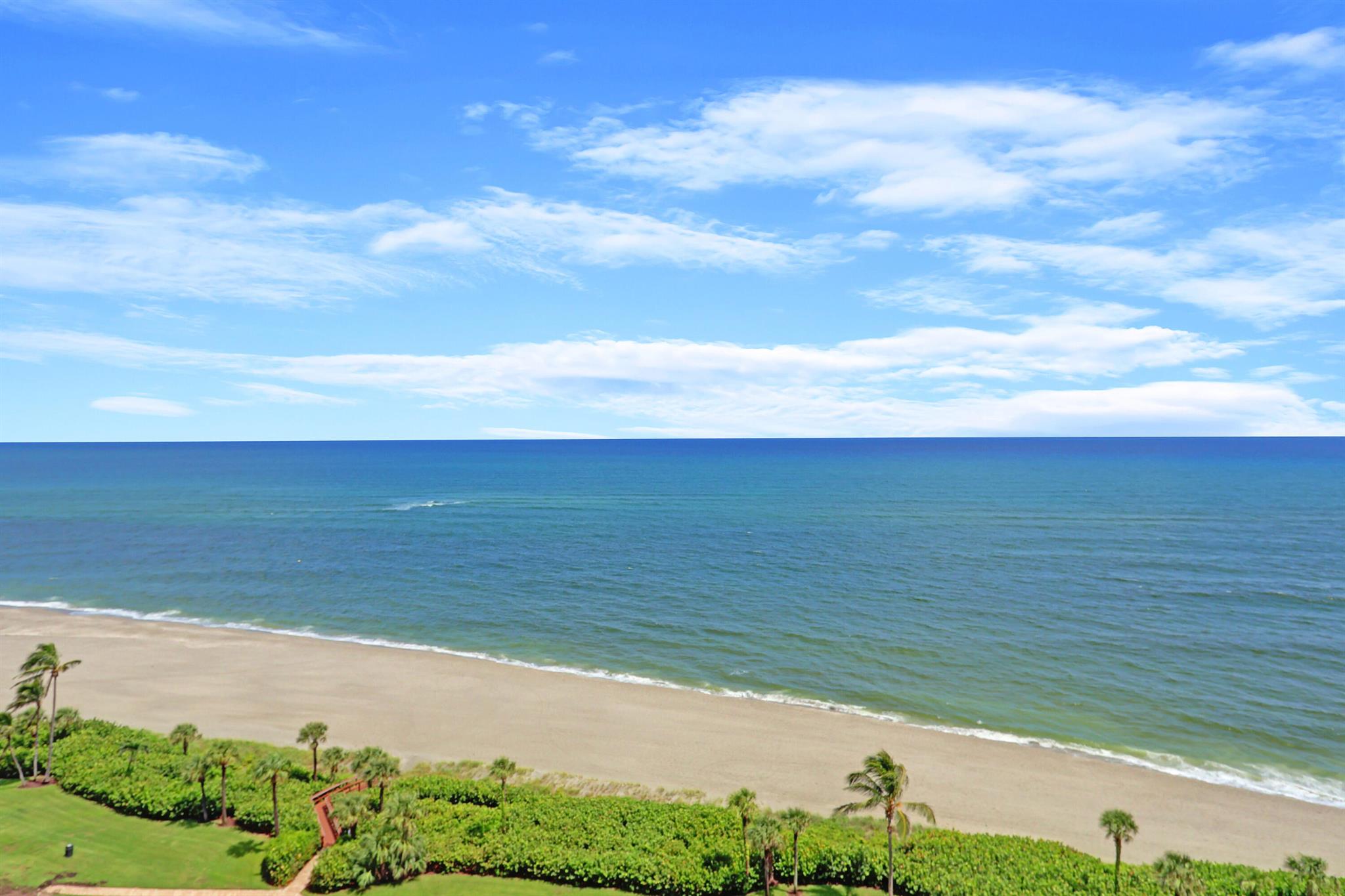 Experience luxurious, resort-style living and sweeping ocean views in this stunning, recently renovated direct oceanfront PENTHOUSE condo located in the highly sought-after Ocean Trail. This exquisite newly painted home features all tile floors throughout--no carpet. The bright, contemporary kitchen boasts white cabinetry, quartz countertops creating an inviting space perfect for entertaining. Bathrooms are outfitted with a stylish vessel sink, white cabinetry & granite countertops. Ocean Trail is the only community in Jupiter located directly on the sand, offering access to a white sand beach just steps away from your front door. The community provides a wealth of amenities, including a resort-style pool, fitness room, a club room, tennis courts, a manned guard gate, & on site management