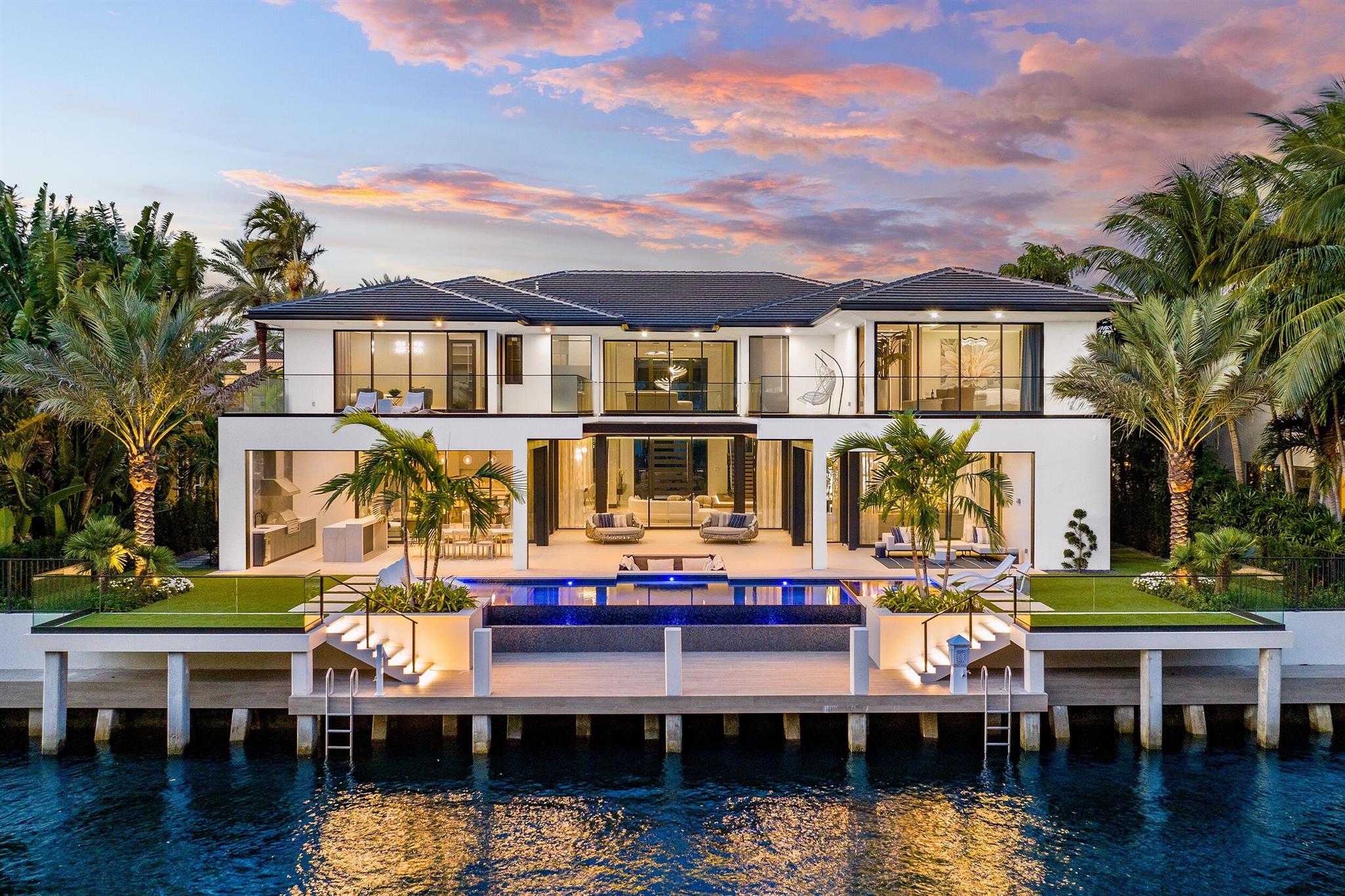 212 W Alexander Palm Rd | Brand new contemporary waterfront masterpiece sits on 100 ft of Royal Palm Waterway in Boca Raton's most prestigious community, Royal Palm Yacht & CC. Built by Albanese & Sons, Architecture by BE Designs, & Interiors by Zelman Design. This turnkey estate features 11,400 total sf. 6 BD's 8.1 BA's, Enter into 2 story Lit Foyer,the amazing Living Room w/ lavish private views of Capone Island. Private office, club room w/ bar & multiverse entertainment center and lavish wine room, 2-way marble fireplace, formal dining, family Rm leads to dream chef's kitchen w/ luxury appliances, 4-car plus golf. 2nd Floor Primary Suite, Wellness Rm w/sauna & Steam Shower, Gym. Southern Exposure W/Infinity Edge Pool & Spa, Sunken Fire Pit, Control 4 smart House, Generator & Elevator.