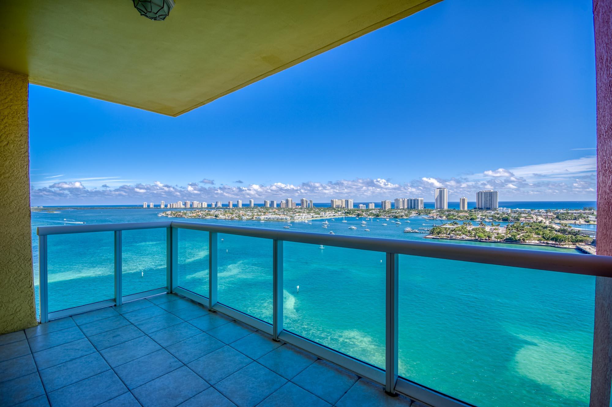 Experience luxurious coastal living in this exquisite 19th floor condo of the highly desired 2640 building offering the best breathtaking views of the Intracoastal and the ocean. From the expansive balcony, enjoy panoramic vistas of Peanut Island, Little Munyon, Singer Island, and the mesmerizing turquoise waters. Witness stunning sunrises each morning from the comfort of your own home. This spacious 2-bedroom, 2-bathroom condo is a perfect canvas, ready to move-in or customize to your liking. Featuring elegant laminate floors throughout the living areas and tile in the kitchen and bathrooms, this unit is designed for both style and functionality. The modern kitchen boasts stainless steel appliances, sleek granite countertops, and modern cabinetry. The primary bedroom is a true retreat, complete with two walk-in closets featuring custom closet systems for optimal organization. Marina Grande offers an array of newly renovated top-notch amenities, including tennis, pickleball, bocce ball, a resort-style pool and spa, a grill area, a fireplace, and a community room. Additionally, the community provides valet services and a manned security gate, ensuring convenience and peace of mind. Whether you seek relaxation or recreation, this community has it all. **Some of the photos have been virtually staged to show what you can do with the space**