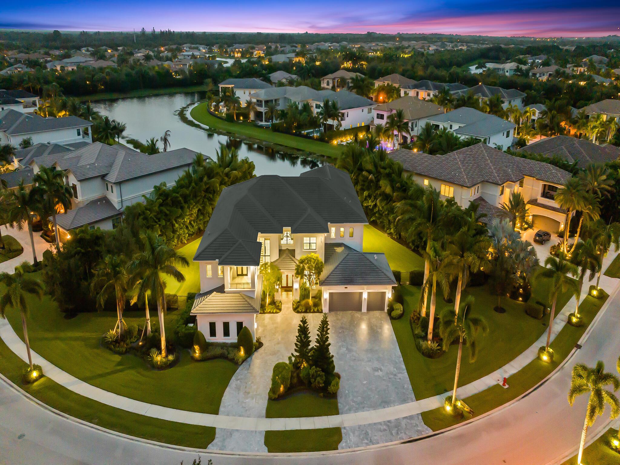 This Special Expanded Vanderbilt Grande model is Lakefront, on a 3/4 Acre 'double' lot!! Offering 6 bedrooms, plus loft, office, media room, 8 full & 2 half baths, 2 laundry rooms, 5 car garage, the estate style home totals 11,567 sq ft (8,017 under air) surrounded by wide lake views and lush, treed, mature and newly planted garden vistas. Retreat outdoors with all the comforts of home using telescoping impact doorwalls off living room, to exterior dining space & summer kitchen. Optional motorized privacy screens compliment the space.  Enjoy fabulous sunsets from sprawling patio & balconies, salt water pool & spa with heater/chiller, private putting green, fenced green space for playground or dog run.Home Upgraded throughout. Indoor elevator. Home generator. Water filtration. EV charger