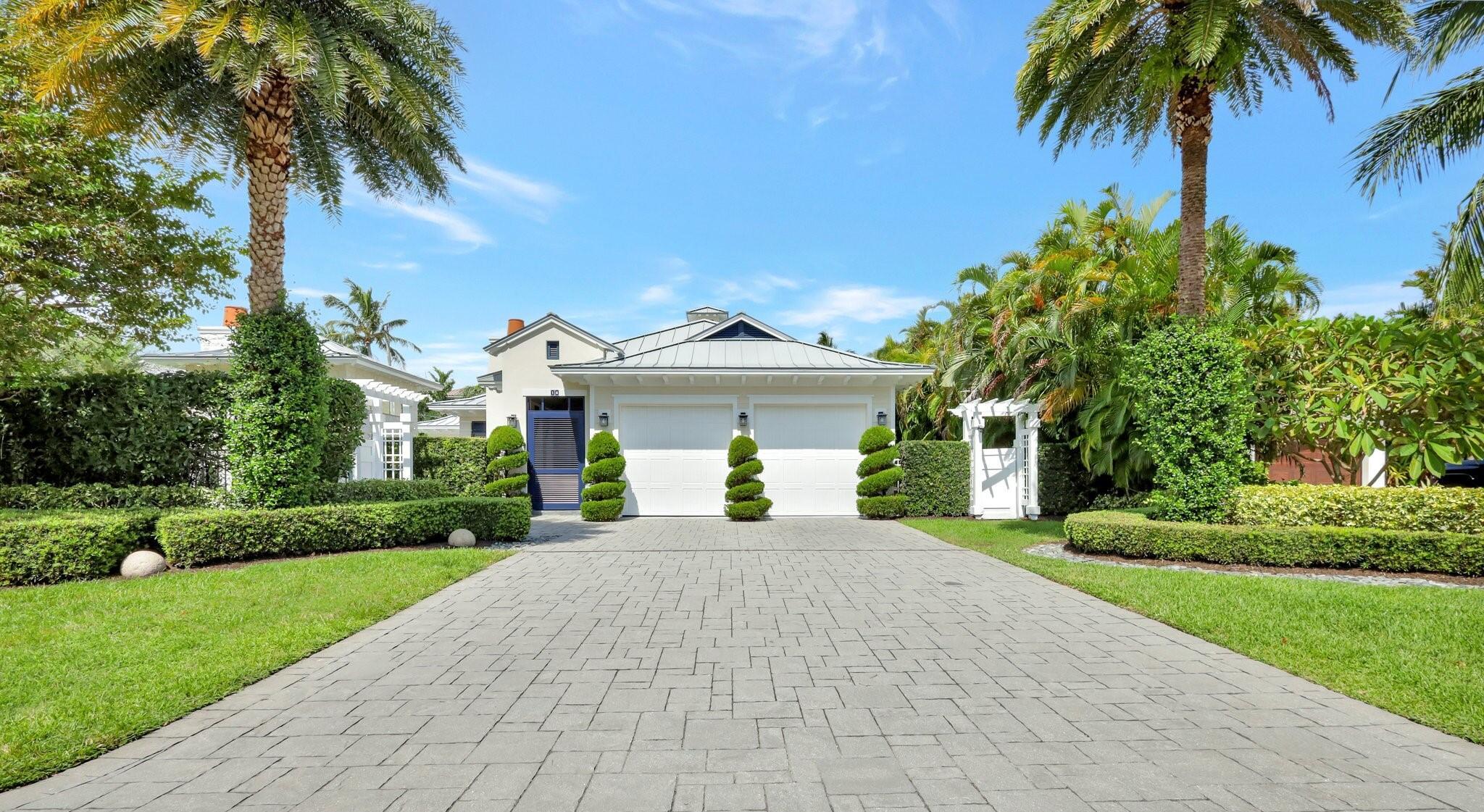 Be prepared to be captivated by this spectacular West Indies-inspired estate, nestled in the heart of the exclusive Ocean Ridge community. Set on an expansive corner lot spanning over 1/4 acre, this tropical paradise offers over 2,700 SF of luxurious living space, including a separate guest house, 660 SF covered patio and exclusive deeded access to a private beach, making it an exceptional coastal retreat. Built in 2014 with meticulous attention to detail and no expense spared, this stunning home exudes sophistication and craftsmanship. As you approach, you'll be greeted by lush landscaping and a charming Bimini-shuttered breezeway, with a washed gray wood ceiling, leading you into an oasis that feels like an island getaway. Inside, soaring vaulted wood ceilings and an open floor plan create an inviting ambiance that flows seamlessly from the great room to the kitchen and expansive outdoor living spaces. The spacious great room, bathed in natural light, serves as the heart of the home, connecting effortlessly to both the gourmet kitchen and the vast covered patio. The kitchen itself is a chef's dream, featuring custom white shaker cabinetry, elegant Carrara marble countertops and backsplash, a generous island with an apron-front sink, and top-tier appliances. Nearby, a pantry provides ample storage, ensuring both style and functionality. The private master suite is a tranquil retreat, featuring vaulted wood ceilings and French doors that open directly to the pool and patio area. Two custom-designed walk-in closets provide abundant space, while the spa-like master bathroom boasts dual vanities with Carrara marble counters, a large walk-in shower with a bench, a freestanding soaking tub, and a separate water closet. A second master suite or guest room is thoughtfully positioned off the dining room, complete with custom built-ins, a walk-in closet with a barn door, and an ensuite bath for ultimate convenience. Step outside, and you'll find your own tropical sanctuary. The expansive covered patio is an outdoor living room in itself, complete with multiple lounge areas and a gas fireplace, perfect for entertaining or unwinding. The shimmering pool is surrounded by lush landscaping, offering privacy and serenity. The nearby guest house provides a charming retreat for visitors or family, with its own space for relaxation. Additional outdoor features include a private outdoor shower, a tranquil bubbling fountain and a fully fenced yard with custom-built arbors. This exceptional home also includes hurricane impact windows and doors throughout, an in-ground propane tank, solid wood interior doors, space-saving pocket doors, elegant crown molding, Bahamian wood shutters, Windsor beadboard, two working fireplaces, tongue and groove wood ceilings, a large laundry room, and an air-conditioned two-car garage. The custom paver driveway adds a touch of elegance to the exterior, while the absence of an HOA offers freedom and flexibility. Best of all, you're just a short stroll away from the private, gated beach access. Perfectly situated in the charming seaside town of Ocean Ridge with its own police force and close proximity to a variety of private schools. This home is conveniently close to the vibrant Atlantic Avenue in Delray Beach and world-class shopping and dining on Palm Beach's iconic Worth Avenue. Don't miss your chance to own this exquisite slice of coastal luxury!