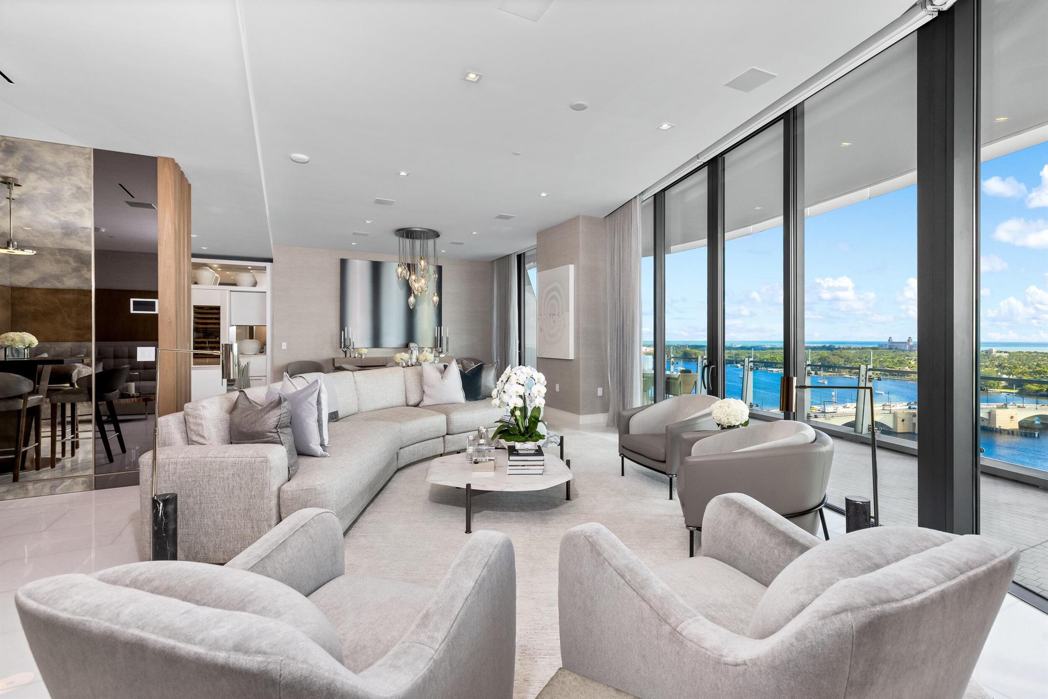 Gorgeous condominium with 3BR/4.1BA plus library, 4,300+/- total square feet, and beautiful views of the Intracoastal, Ocean, and Palm Beach Marina. Stunning custom design by Marc-Michaels Interior Design. Welcoming foyer leads to large great room and family room with water views. State-of-the-art gourmet kitchen features Calcutta countertops, Snaidero cabinetry, and Gaggenau appliances. Spacious waterfront Primary Suite with dual baths and three walk-in closets opens to oversized balcony. Two guest suites feature en-suites, walk-in closets, and fantastic city views. Additional highlights include soaring ceilings, floor-to-ceiling impact doors, and an expansive covered balcony that is perfect for al fresco dining and entertaining. No detail has been overlooked in this pristine condo.