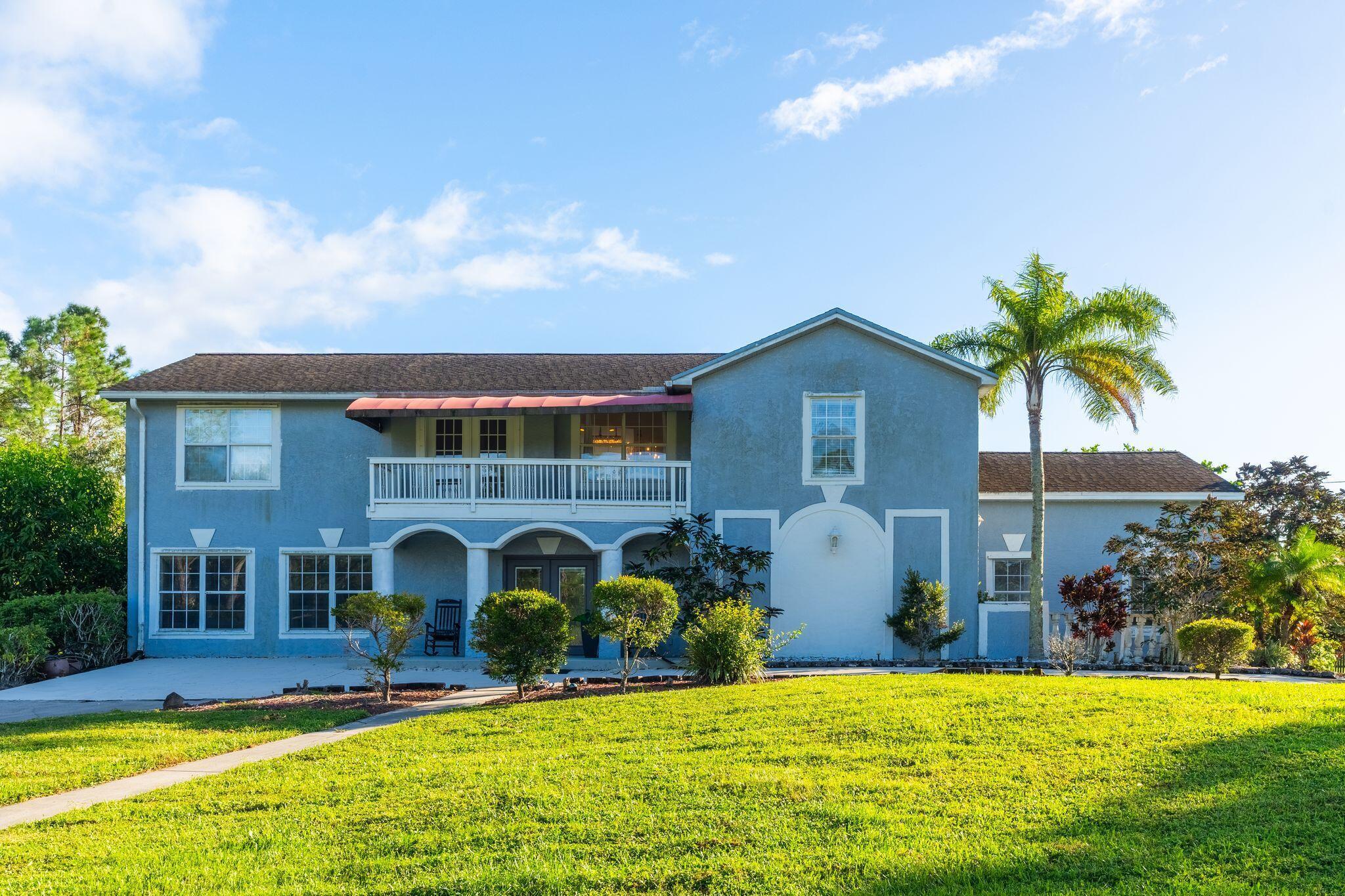 This stunning and massive 5-bedroom, 4-bathroom home offers over 3,400 sq. ft. of spacious living on 1.29 acres in beautiful Loxahatchee. Enjoy ultimate privacy with no HOA and no restrictive rules. Featuring two kitchens, two primary suites, and a split-family living design, this home is perfect for multi-generational living or hosting guests. Large rooms and vaulted ceilings create a bright, open atmosphere. Ideal for entertaining, the property offers endless possibilities for outdoor activities. Whether you're dreaming of keeping chickens, cows, or creating your own backyard oasis, this home brings it all to life.