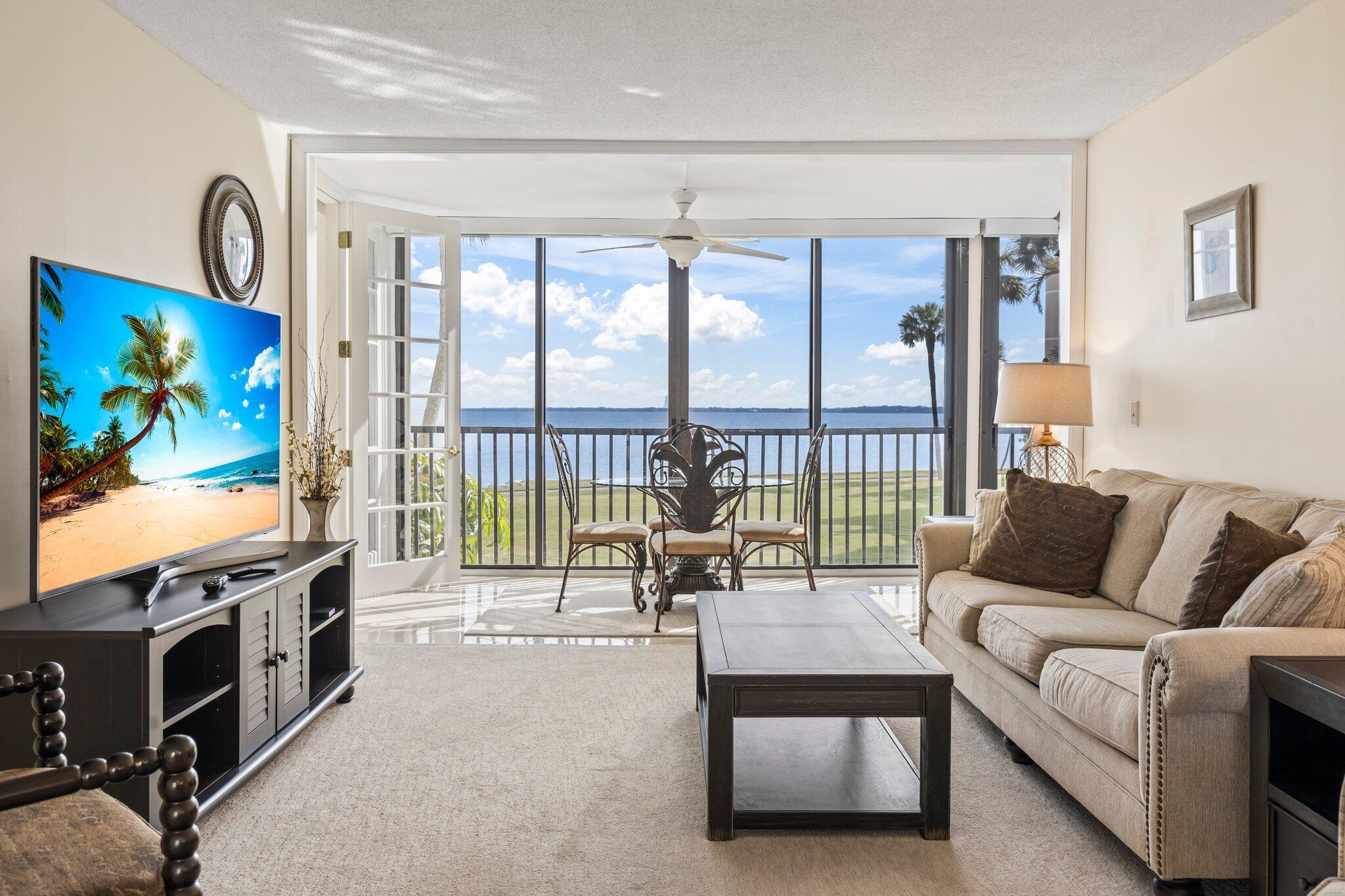 Wake up each morning to the breathtaking views of the Indian River Lagoon from this stunning 2/2 condo in Jensen Beach. With a press of a button, sleek automated blinds reveal a spacious living room that opens to a panoramic vista, featuring the iconic Stuart Bridge in the distance.Flooded with natural light from its southern exposure, the condo creates a bright, airy atmosphere perfect for enjoying your morning coffee or watching sunsets over the water. Just minutes from pristine beaches and vibrant downtown Jensen Beach, this home offers resort-style amenities like a pool, clubhouse, and access to scenic walking trails.This condo is equipped with a new ac, new hot water heater, new LG appliances, Nest thermostat and smoke/CO detectors and motorized blinds in main living areas.